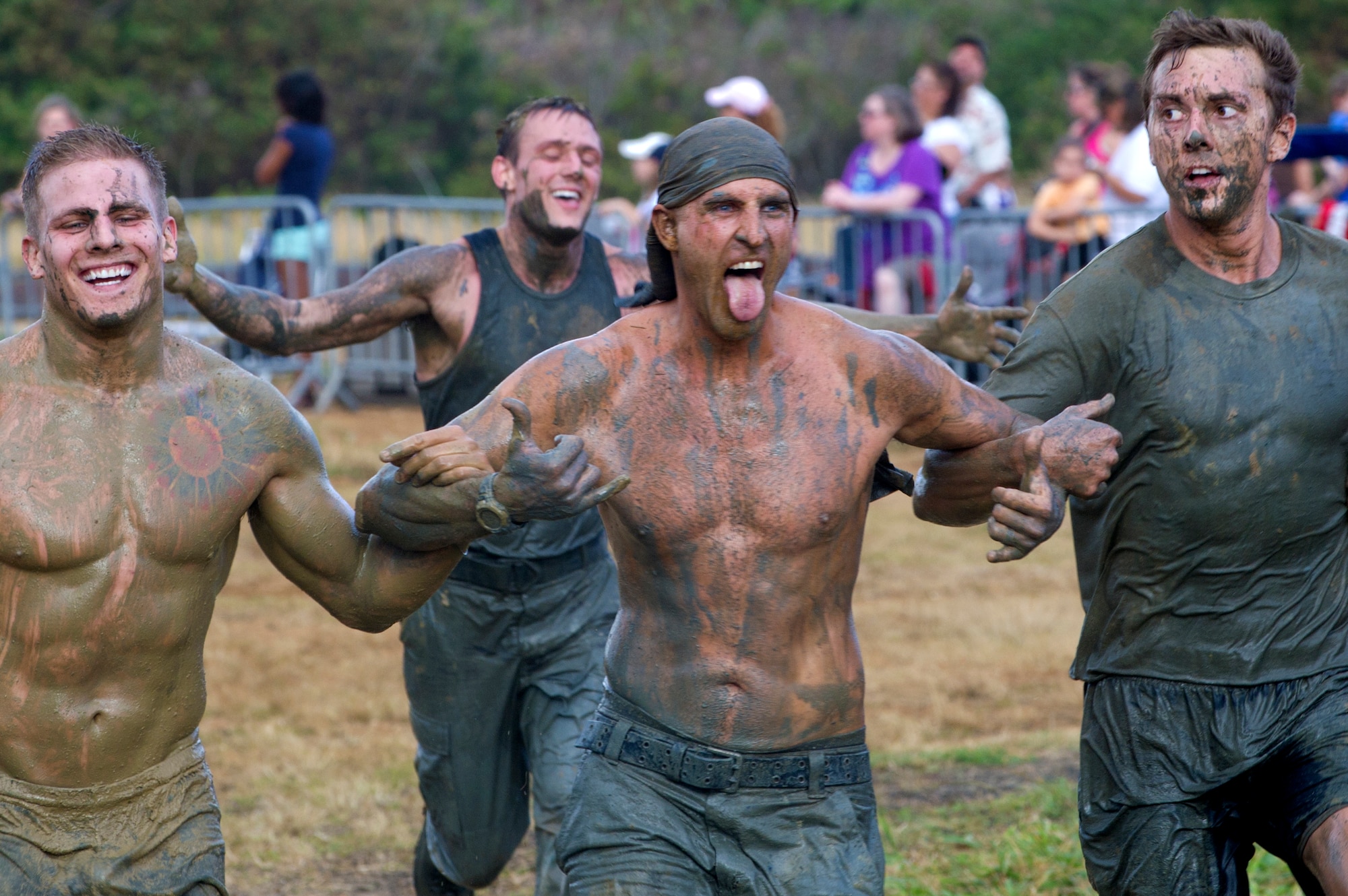 Teams lock arms as they run the last 100 yards of the Swamp Romp, a five-mile run through the mud along the Nu'upia ponds and down the Fort Hase Beach at Marine Corps Base Hawaii - Kaneohe Bay Feb. 25, 2012. This unique run, known as the "Dirtiest race in Hawaii" takes teams  over and under the challenge-laden course that included unlimited mud, low crawling, jumping, climbing and falling in the mud. (U.S. Air Force photo/Staff Sgt. Mike Meares)
