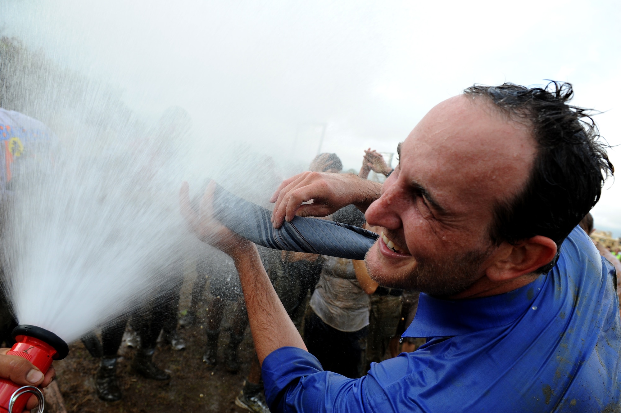A competitor washes off his tie after finishing the Swamp Romp, a five-mile run through the mud along the Nu'upia ponds and down the Fort Hase Beach at Marine Corps Base Hawaii - Kaneohe Bay, Feb. 25, 2012. This unique run, known as the "Dirtiest race in Hawaii" takes teams  over and under the challenge-laden course that included unlimited mud, low crawling, jumping, climbing and falling in the mud. (U.S. Air Force photo/Staff Sgt. Mike Meares)