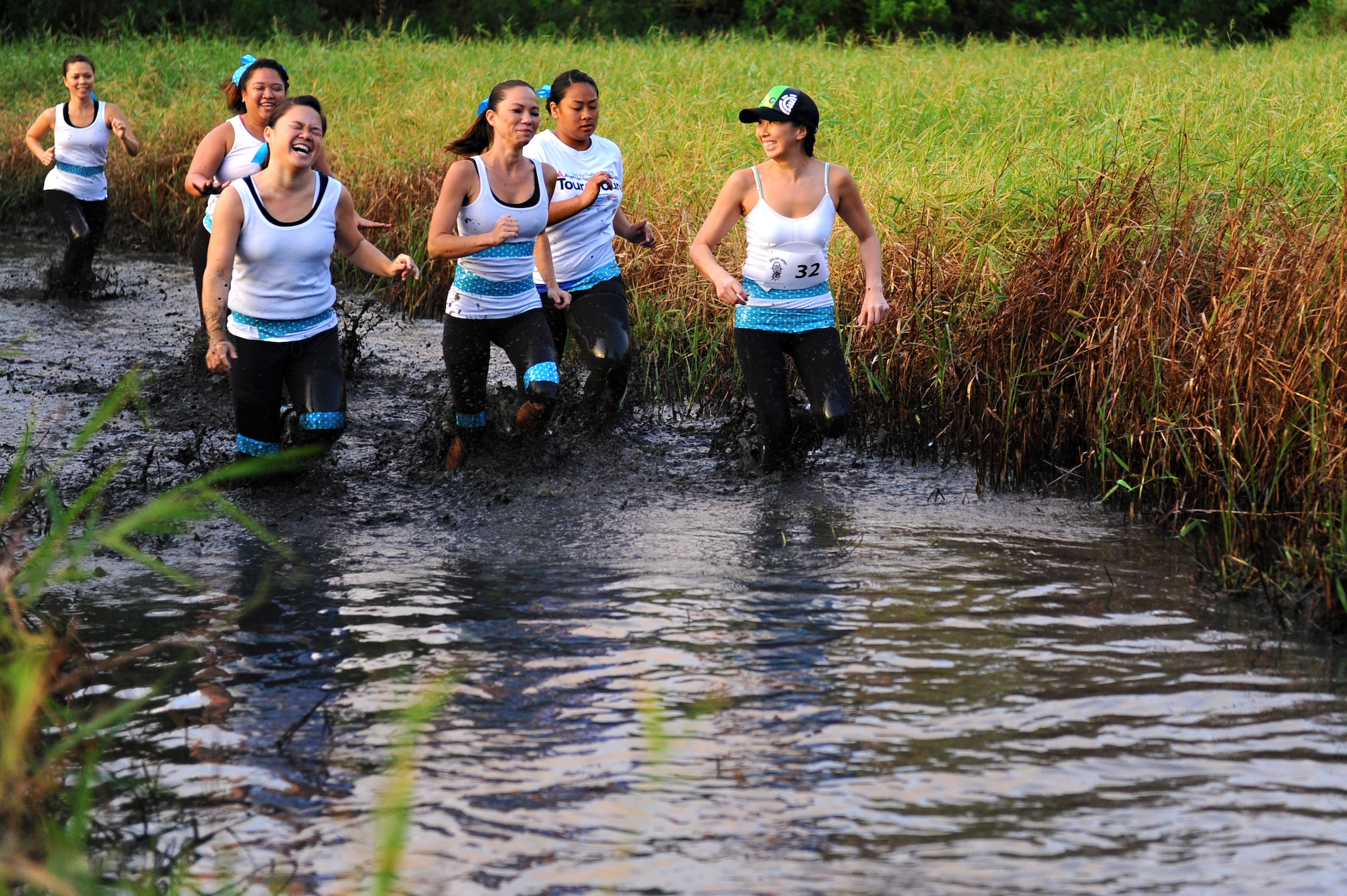 Competitors make their way through the first muddy section of the Swamp Romp, a five-mile run through the mud along the Nu'upia ponds and down the Fort Hase Beach at Marine Corps Base Hawaii - Kaneohe Bay Feb. 25, 2012. This unique run, known as the "Dirtiest race in Hawaii" takes teams  over and under the challenge-laden course that included unlimited mud, low crawling, jumping, climbing and falling in the mud. (U.S. Air Force photo/Staff Sgt. Mike Meares)