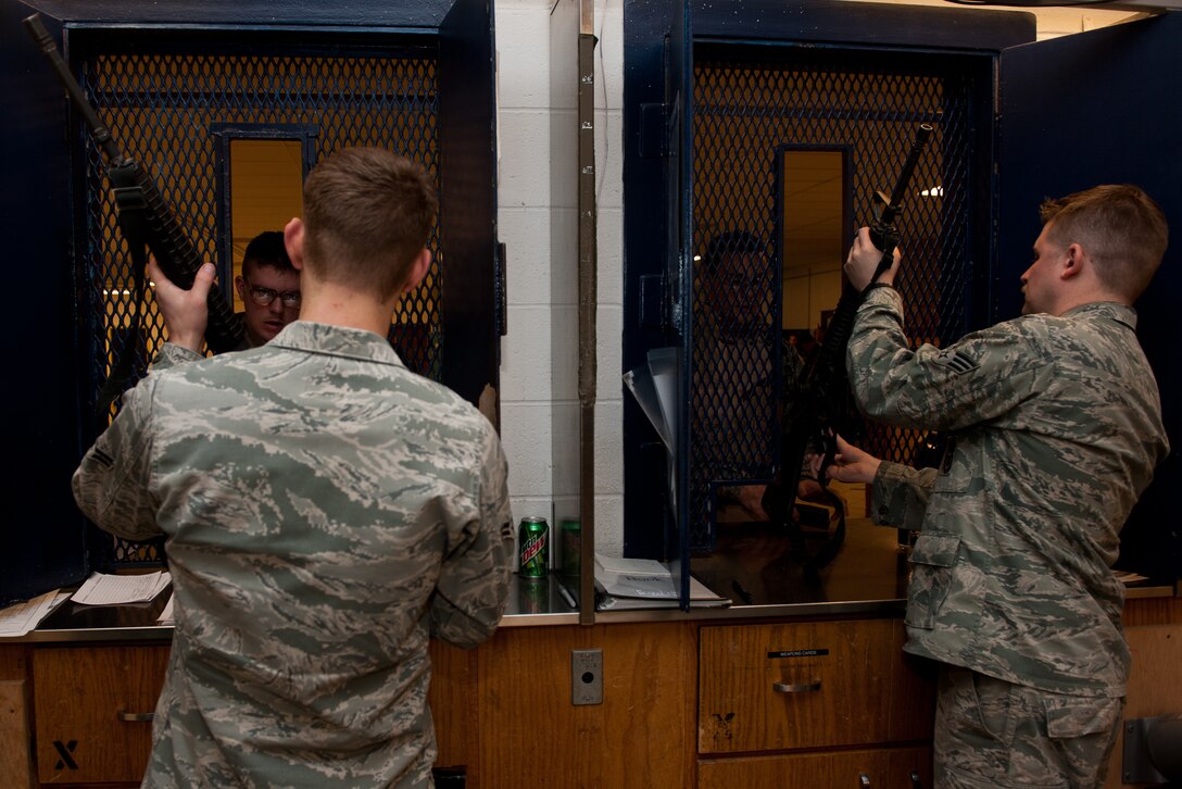 Airmen at the 28th Security Forces Squadron armory issue M-16 A2s to augmentees during an Operational Readiness Exercise at Ellsworth Air Force Base, S.D., Feb. 24, 2012. Augmentees were used during the ORE to increase security at several key locations during periods of heightened security. (U.S. Air Force photo by Airman 1st Class Kate Thornton/Released)
