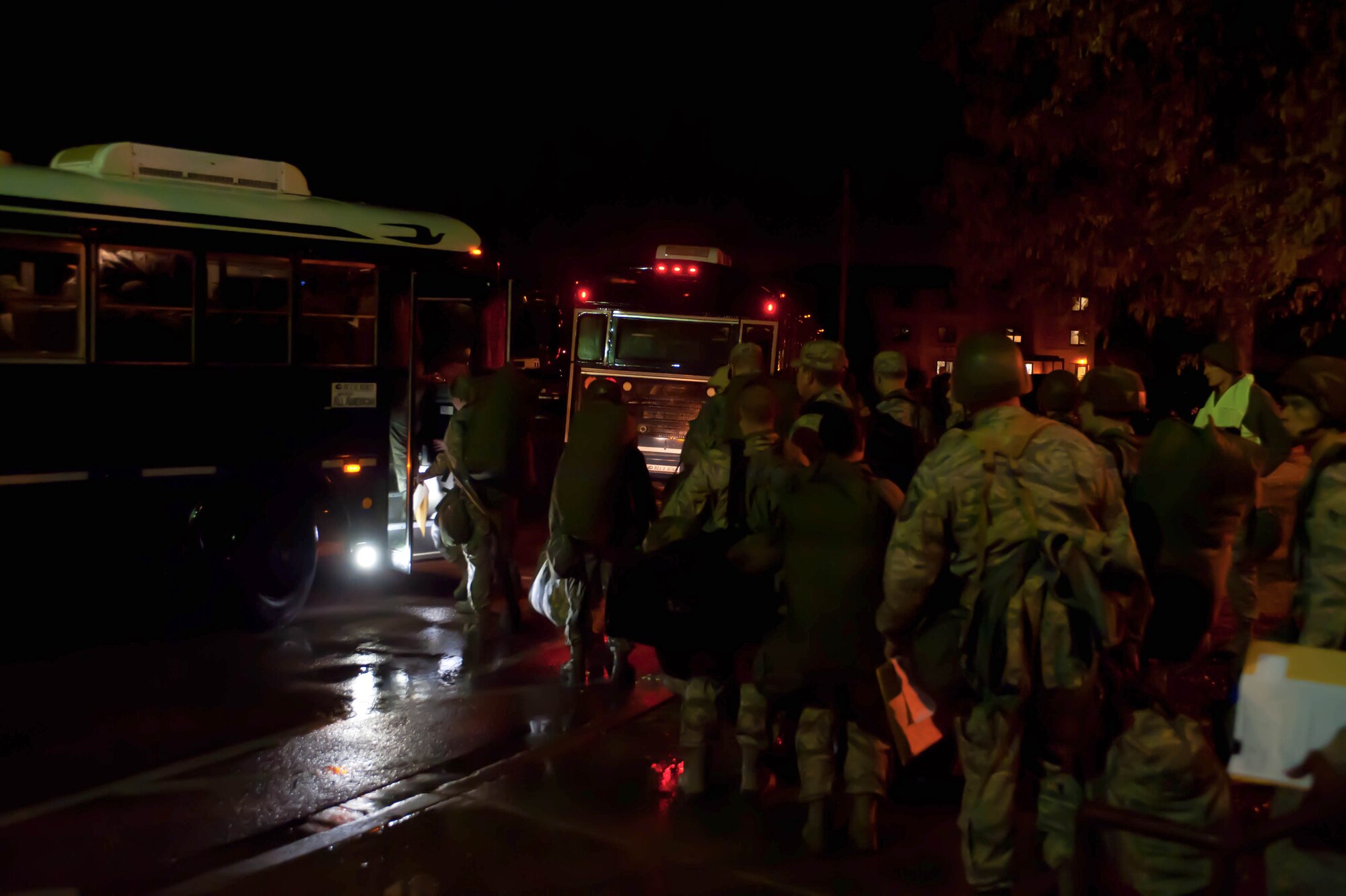 Airmen board buses at the Bellamy Fitness Center to move to the Personal Deployment Function line at the Pride Hangar during an Operational Readiness Exercise on Ellsworth Air Force Base, S.D., Feb. 22, 2012. The ORE prepares Airmen to deploy in support of contingency operations. (U.S. Air Force photo by Airman 1st Class Zachary Hada/Released)