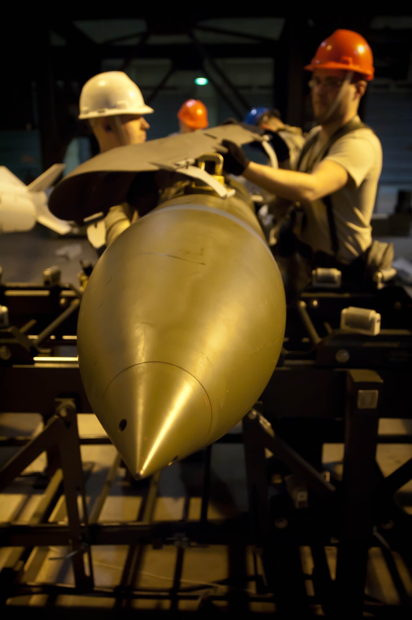 Conventional maintenance crewmembers assigned to the 28th Munitions Squadron assemble and load inert GBU-31V bombs during an Operational Readiness Exercise on Ellsworth Air Force Base, S.D., Feb. 22, 2012. 28th MUNS Airmen provide conventional munitions, armament systems and trained munitions personnel. (U.S. Air Force photo by Airman 1st Class Zachary Hada/Released)