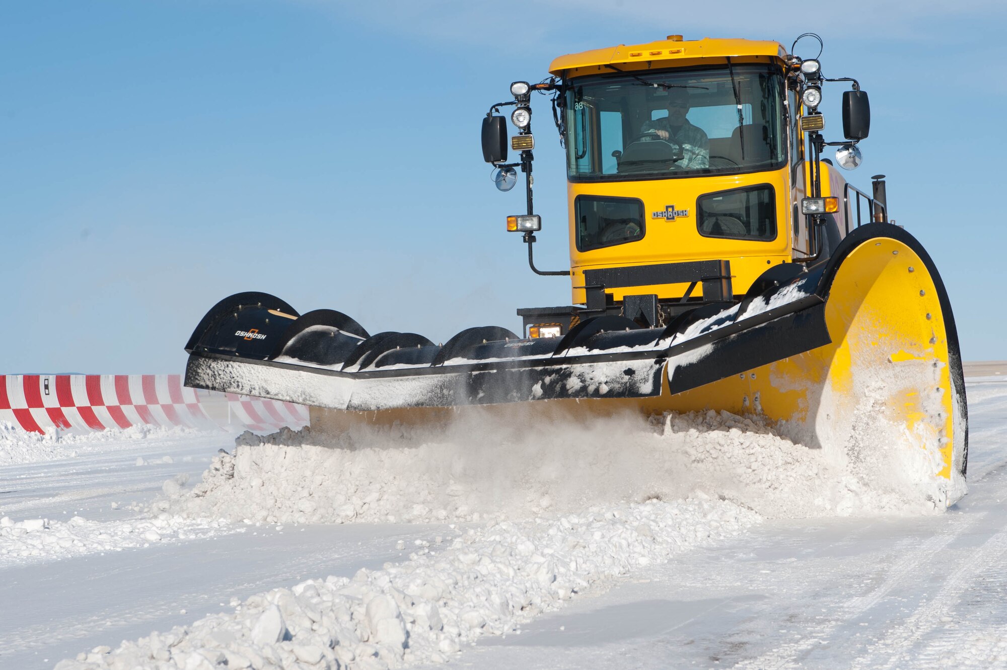 Kevin Holman, 28th Civil Engineer Squadron heavy equipment operator, clears the runway at Ellsworth Air Force Base, S.D., Feb. 29, 2012. The flightline is carefully plowed to ensure flightline operations are uninterrupted. (U.S. Air Force photo by Airman 1st Class Zachary Hada/Released)