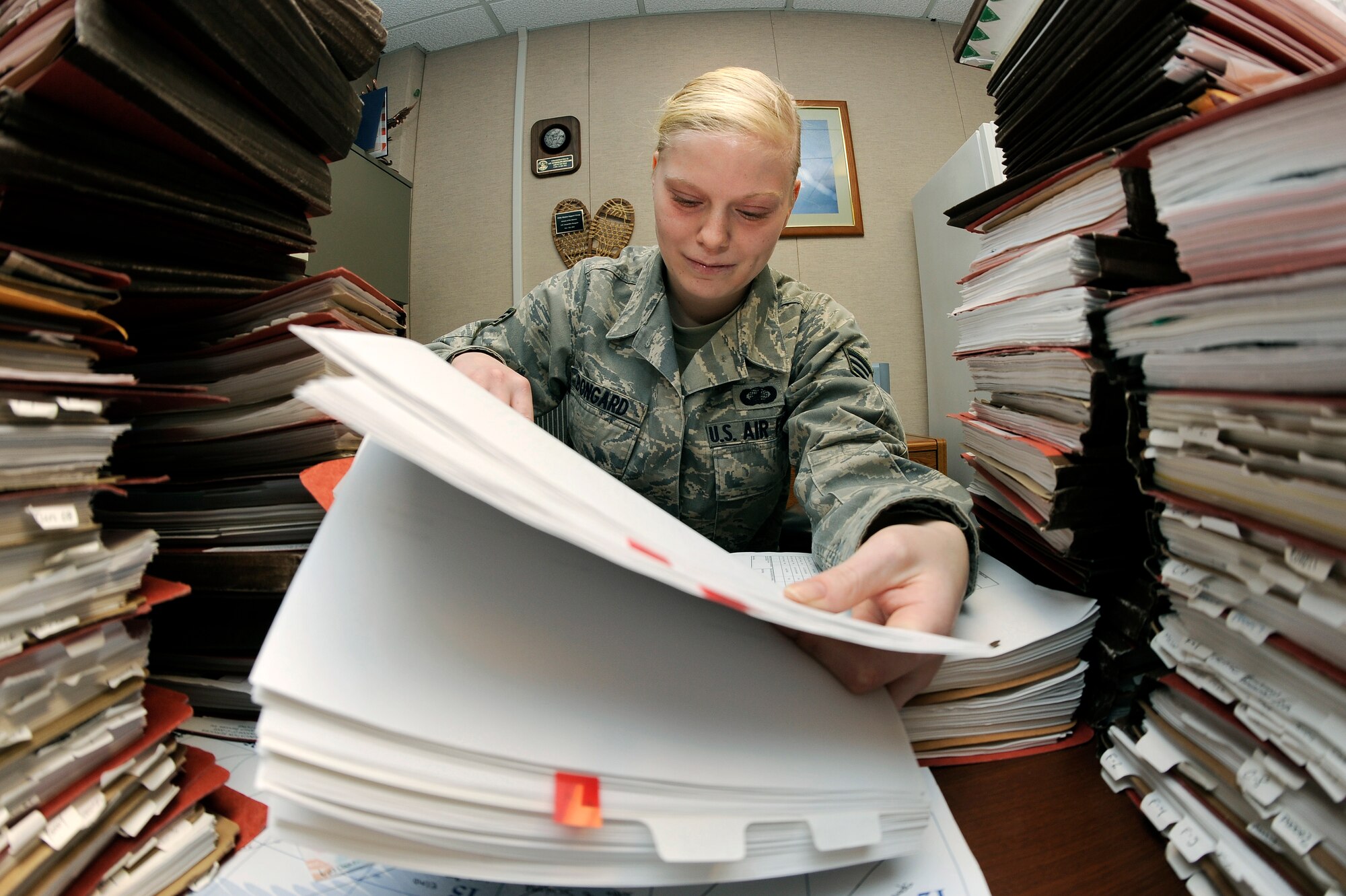 U.S. Air Force Senior Airman Jacqueline Bongard, 354th Contracting Squadron contracting specialist, performs a contract file review Feb. 29, 2012, Eielson Air Force Base, Alaska. Bongard ensures base contractors are paid an agreed amount according to their respective contracts. (U.S. Air Force photo/Staff Sgt. Jim Araos)