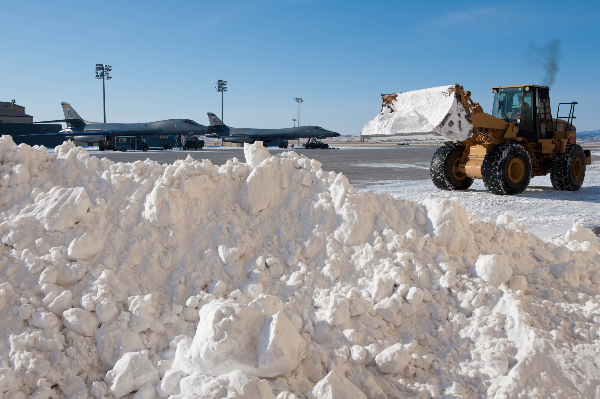 Airman 1st Class Nick Eslick, 28th Civil Engineer Squadron pavement and construction equipment operator, uses a front-end loader to remove snow from the flightline at Ellsworth Air Force Base, S.D., Feb. 29, 2012. Pavement and construction equipment specialists operate and maintain heavy construction equipment such as front-end loaders, bulldozers, dump trucks, skid steer loaders and road graders to keep operations at Ellsworth running seamlessly. (U.S. Air Force photo by Airman 1st Class Zachary Hada/Released)