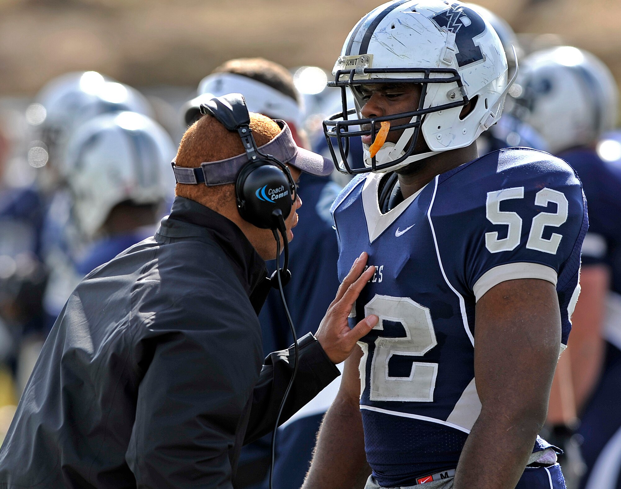 Capt. Nathan Allen talks with Cadet Candidate Yohance Salimu during an Air Force Academy Preparatory School football game Oct. 29, 2011. Salimu, a native of Los Angeles, spent much of his high school years homeless after his family lost their home in 2008. Allen is a coach for the Prep School's Huskies football team. (U.S. Air Force photo/Maj. Kristina Meyle)