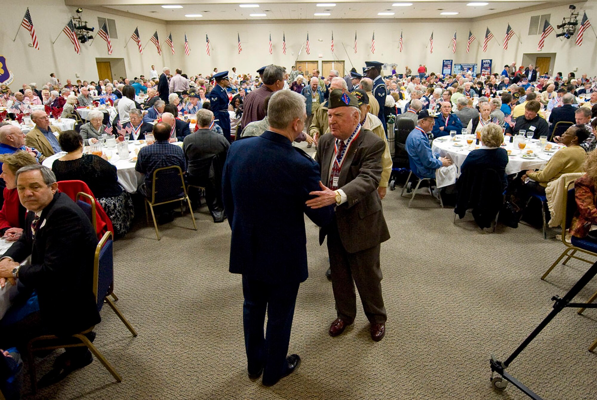 Col. Tim Fay, 2nd Bomb Wing commander, greets veterans during the World War II veterans luncheon on Barksdale Air Force Base, La., Feb. 24. Approximately 700 WWII veterans and their family members were in attendance at the annual gathering. (U.S. Air Force photo/Senior Airman Chad Warren)(RELEASED)
