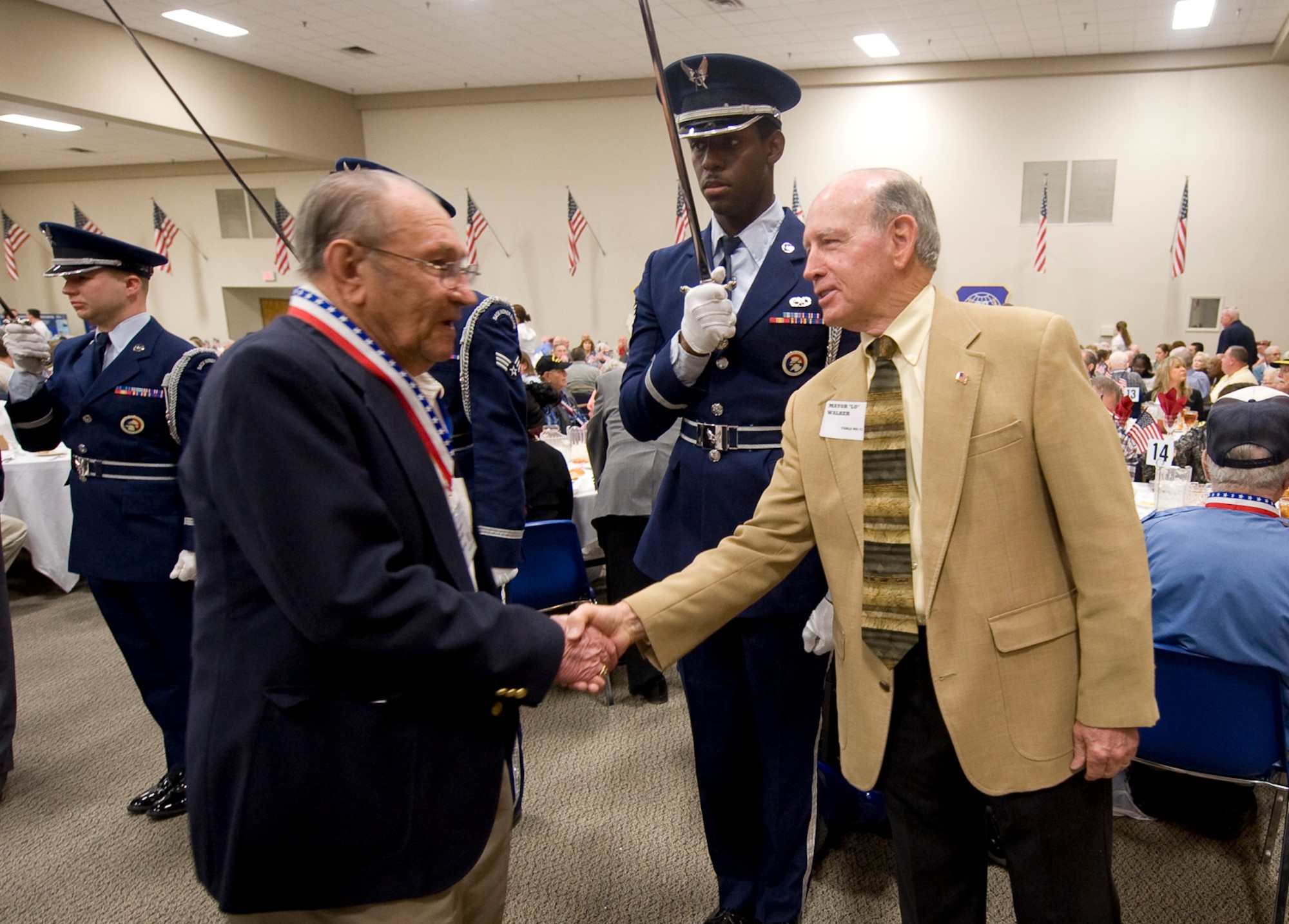 Bossier City Mayor Lorenz Walker greets a World War II veteran during the WWII veterans luncheon on Barksdale Air Force Base, La., Feb. 24. Veterans from all services are invited to this annual event and honored for their contributions during the war. (U.S. Air Force photo/Senior Airman Chad Warren)(RELEASED)