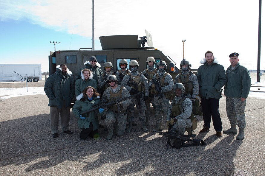 Col. Tom Wilcox, 90th Security Forces Group commander; Joseph Jones, military legislative assistant, Sen. Tom Harkin (D-IA); Wendy Gnehm, military legislative assistant; Sen. Mike Enzi (R-WY); Sierra Forbes, military legislative assistant; Sen. Mike Crapo (R-ID); Josh Hodges, military legislative assistant; Sen. David Vitter (R-LA); Landon Stropko, military legislative assistant; and Rep. Cynthia Lummis (R-WY) pose for a photograph with members of the 90th Security Forces Tactical Response Force after viewing a TRF demonstration at Uniform-02 Feb. 24. (U.S. Air Force photo by Matt Bilden