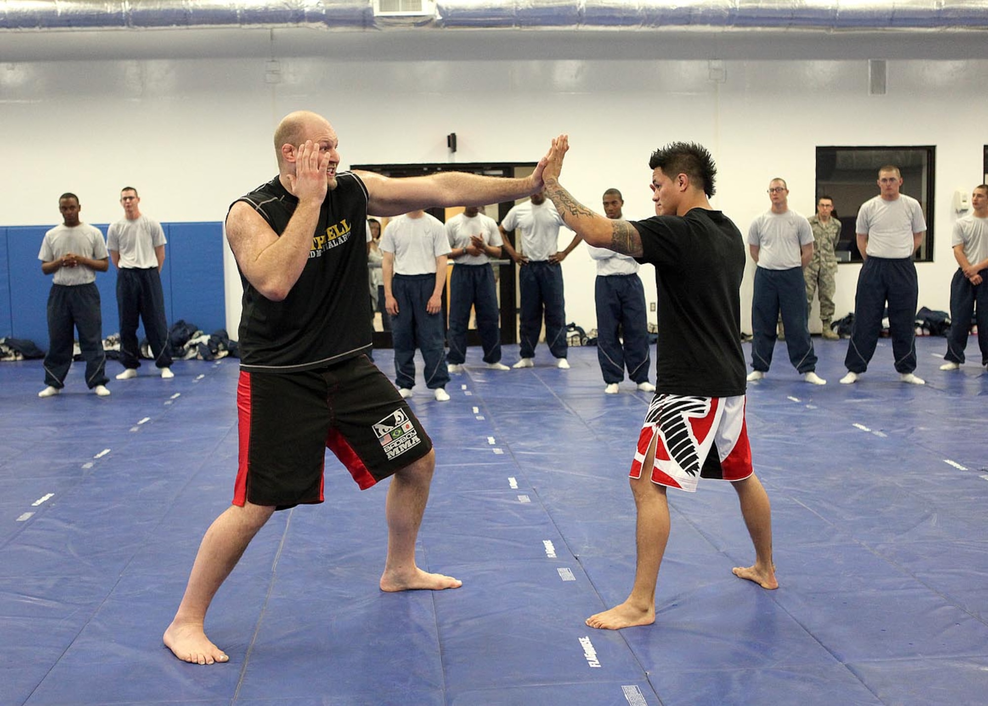 Ultimate Fighting Championship competitors Ben Rothwell and Reuben Duran perform various grappling techniques and styles for technical school students from the 342nd, 343rd and 344th Training Squadrons during a demonstration Feb. 25 at Joint Base San Antonio-Lackland, Texas. (U.S. Air Force photo/Robbin Cresswell)