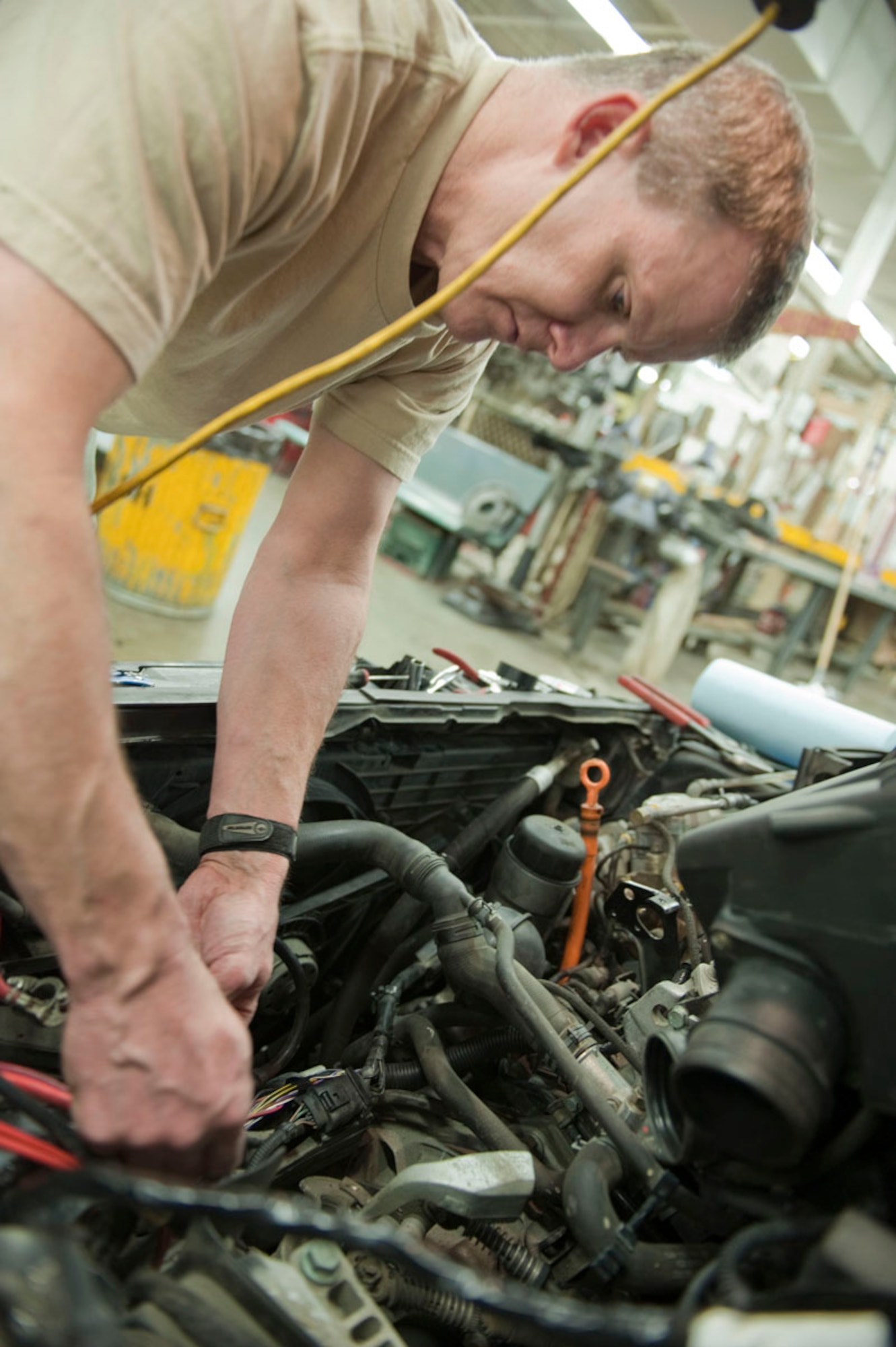 Air National Guard Master Sgt. Curtis Graham replaces a glow plug harness in his Volkswagon Jetta at the Joint Base Elmendorf-Richardson Polar Express Auto Arts and Crafts Center Feb. 25. The Auto Arts and Crafts Center will merge with the Far North Arts and Crafts Center March 18. The Far North Center will officially close March 11. Graham is a metal techology supervisor for the 176th Maintenance Squadron and native of Eagle River, Alaska. (U.S. Air Force photo/Staff Sgt. Robert Barnett)