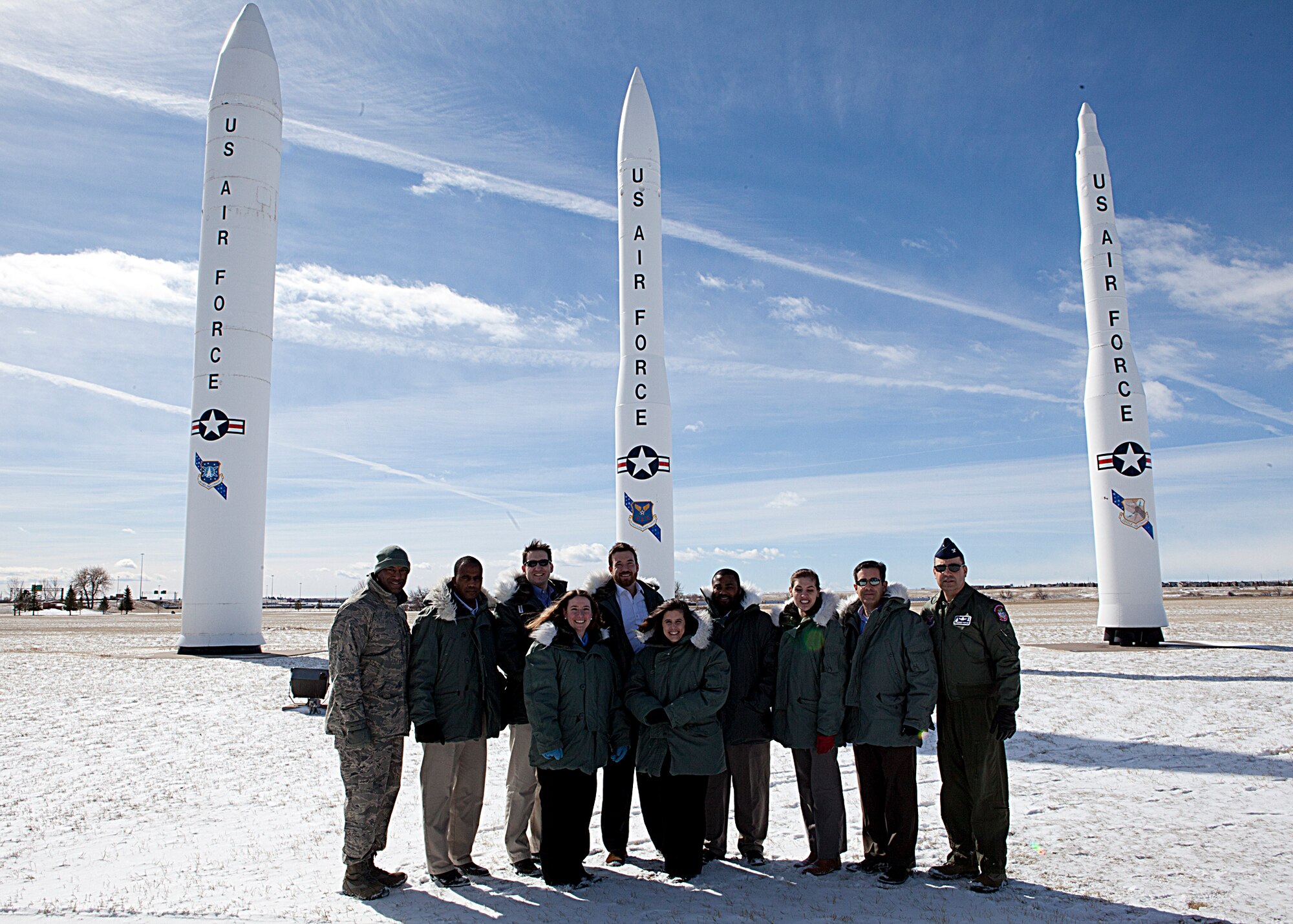 Col. George Farfour, 90th Missile Wing vice commander, Staff Delegation members; Joseph Jones, Military Legislative Assistant; Senator Harkin (D-IA); Wendy Gnehm,  Military Legislative Assistant; Senator Mike Enzi (R-WY); Mrs. Sierra Forbes,  Military Legislative Assistant, Senator Mike Crapo (R-ID); Josh Hodges, Military Legislative Assistant; Senator David Vitter (R-LA); Landon Stropko, Military Legislative Assistant; Representative Cynthia Lummis (R-WY); Lt. Col. Sean Bales SAF/FMBL; Maj. Selby Redman AF/REI; Marco Jaramillo Department of Air Force Civilian, Air Force Global Strike Command and Maj. David Wilson, 90th Contracting Squadron commander pose for a photograph in front of the missiles at  the front gate during the Staff Delegation visit to F. E. Warren Air Force Base, Feb. 24. (U.S. Air Force photo by Matt Bilden
