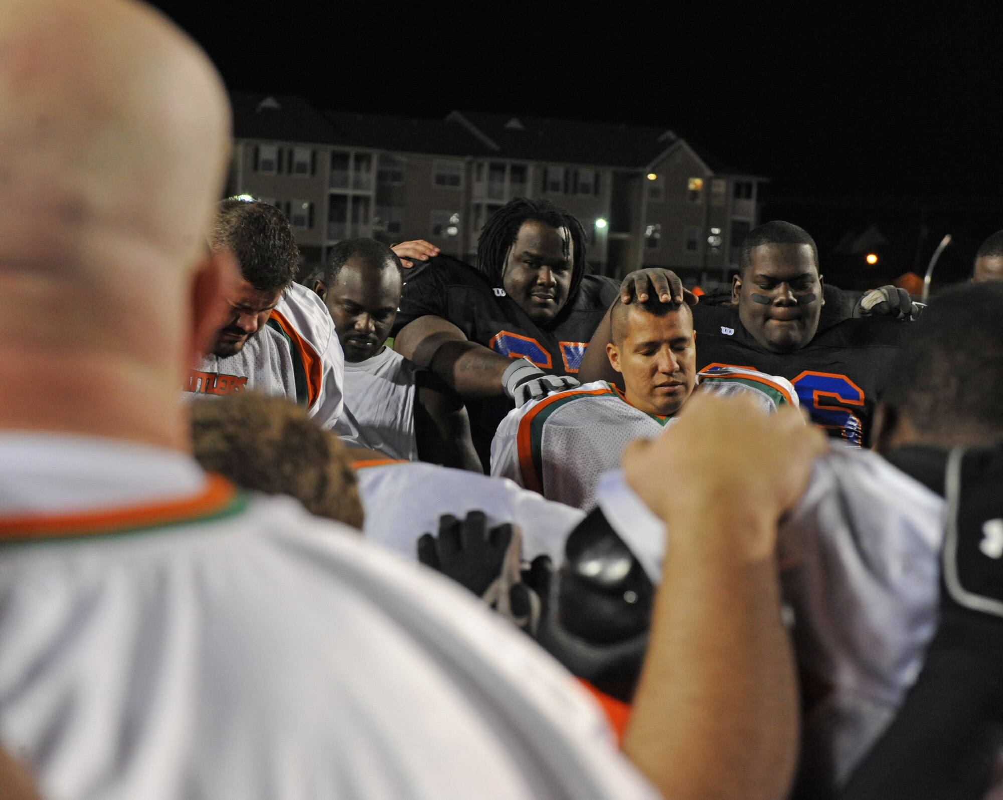 Players from the Shreveport-Bossier Knights and the Collin County Rattlers pray together after their football game at Lee Hedges Stadium in Shreveport, La., Feb. 25. The Rattlers defeated the Knights 55-0, however the Knights will have a second shot at the Rattlers May 5 at the Tom Kimbrough Stadium in Murphy, Texas. (U.S. Air Force photo/Airman 1st Class Micaiah Anthony)(RELEASED)