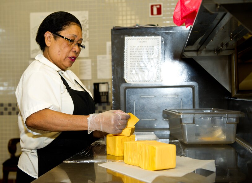 Salcita Linley, a food service worker with Howard and Blackstone, prepares sandwiches for box lunches at the Flight Line dining facility, Robins Air Force Base, Ga., Feb. 15, 2012.  Salcita works the nightshift ensuring workers have meals available during the evening when other base restaurants are closed.  (National Guard photo by Master Sgt. Roger Parsons/Released)