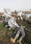 Lead firefighter Jeffery Newman, 802nd Civil Engineer Squadron, aids Senior Airman Ismael Perez, 59th Medical Wing, who is playing the role of an injured pilot during a recent Major Accident Response Exercise at Joint Base San Antonio-Lackland. Events like the MARE, which simulated the crash of an aircraft, test the response capabilities of emergency management and support organizations on base. Similar exercises prepare Air Force organizations for real-world emergencies, and for evaluations like the weeklong Air Education and Training Command Compliance Inspection, which begins Monday. (U.S. Air Force photo/Robbin Cresswell)