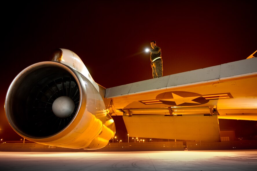 Air National Guard Staff Sgt.  Derrick Donnelly, 116th Air Control Wing, inspects the engine and upper wings of an E-8 Joint STARS that just returned from a night mission at Robins Air Force Base, Ga., Feb. 15, 2012.  Donnelly, a crew chief with the 116th, is responsible for ensuring the JSTARS aircraft is safe and mission ready at all times.  (National Guard photo by Master Sgt. Roger Parsons/Released)