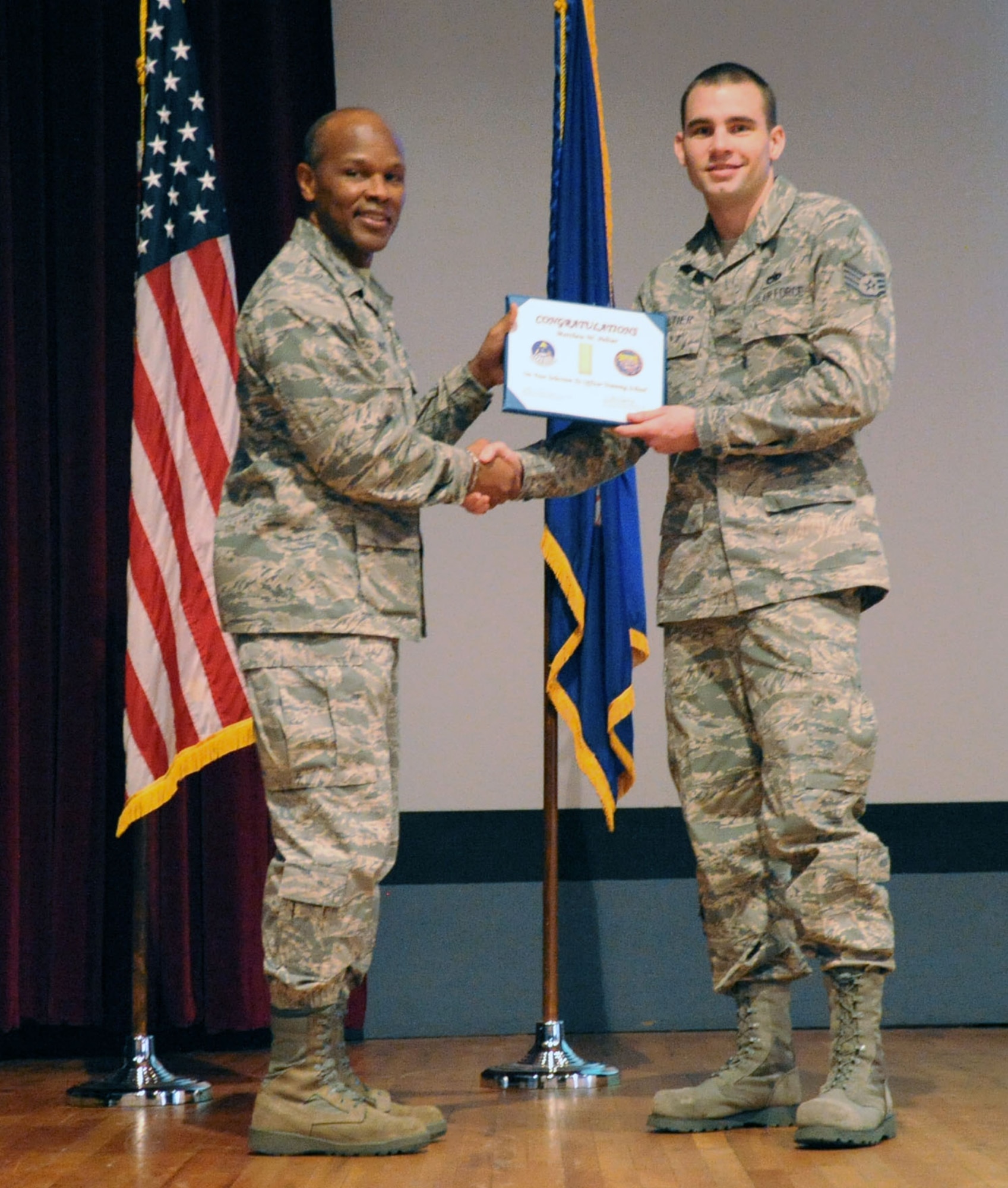 Staff Sgt. Matthew Peltier, an A-10 maintenance instructor assigned to the 362nd Training Squadron, is congratulated on his selection for Officer Training School by Col. Willie Holt, 82nd Training Group commander, during a commander's call at Sheppard Air Force Base, Texas Mar. 1, 2012.  Peltier, along with 29 other active-duty Airmen, was selected to be an officer by the first Rated Officer Board of 2012.  (U.S. Air Force photo/Josh Wilson)