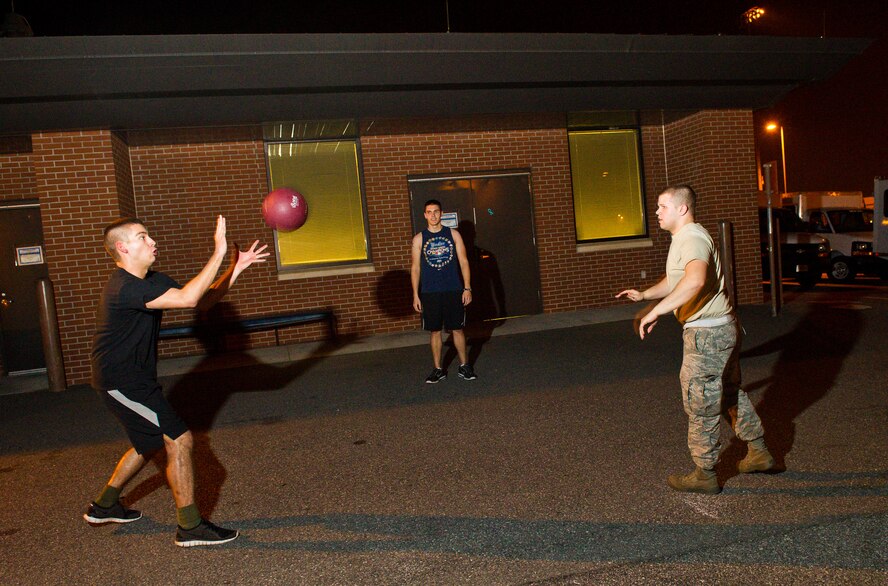 U.S. Air Force Airmen from the 116th and 461st Air Control Wings, take time out for some exercise using a medicine ball for a game of catch at Robins Air Force Base, Ga., Feb. 15, 2012.  The E-8 Joint STARS maintenance personnel have a gym and exercise equipment available in their work area which helps them meet their fitness goals while accomplishing the JSTARS mission. 
(National Guard photo by Master Sgt. Roger Parsons/Released)
