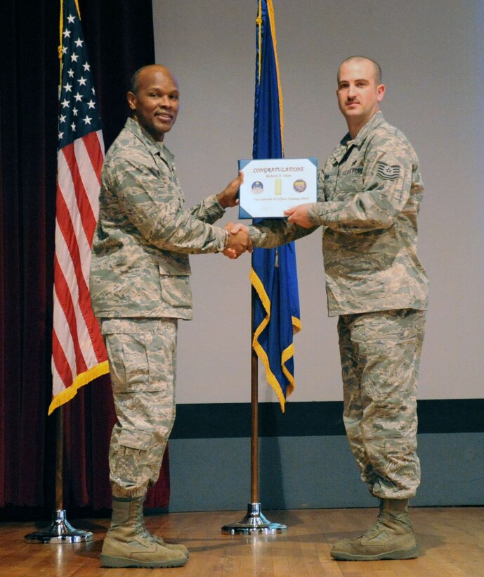Tech. Sgt. Richard Olsen, an F-16 instructor supervisor assigned to the 362nd Training Squadron, is presented an officer promotion certificate by Col. Willie Holt, 82nd Training Group commander, during a commander's call at Sheppard Air Force Base, Texas Mar. 1, 2012.  Olsen, along with 29 other active-duty Airmen, was selected to be an officer by the first Rated Officer Board of 2012.  (U.S. Air Force photo/Josh Wilson)