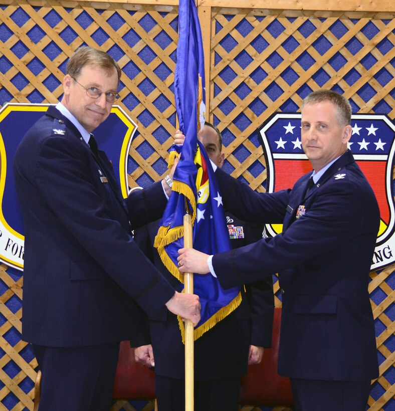 WRIGHT-PATTERSON AIR FORCE BASE, Ohio - Col. Stephen Goeman, 445th Airlift Wing commander, passes the guidon to Col. Brett Newman, incoming 445th Maintenance Group commander, during an Appointment of Command ceremony Feb. 4. Newman assumed command of the group after serving as the 934th Maintenance Group commander at Minneapolis-St. Paul Air Reserve Station, Minn. (U.S. Air Force photo/Senior Airman Mikhail Berlin) 