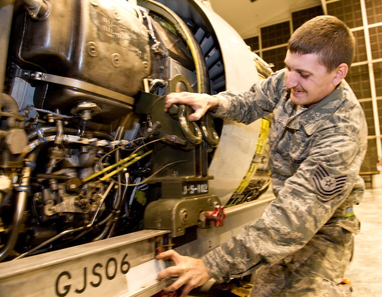 Air National Guard Tech. Sgt. Joshua Gregory, 116th Air Control Wing, slides an E-8 Joint STARS Pratt and Whitney TF33-102C engine in position on an engine change dolly at Robins Air Force Base, Ga., Feb. 15, 2012. Gregory works as a jet engine mechanic in the 116th Engine Shop and is regularly involved in engine change operations.   (National Guard photo by Master Sgt. Roger Parsons/Released)