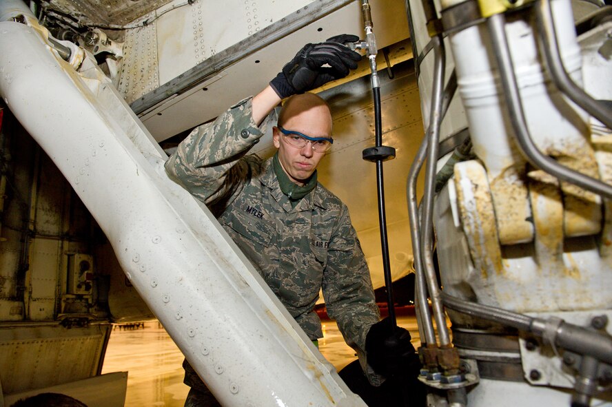 U.S. Air Force Senior Airman Joseph Mylek, 461st Air Control Wing, raises the main landing gear strut on an E-8 Joint STARS at Robins Air Force Base, Ga., Feb. 15, 2012.  Mylek, a crew chief with the 461st, raised the strut to assist the engine shop during an engine change operation.
(National Guard photo by Master Sgt. Roger Parsons/Released)
