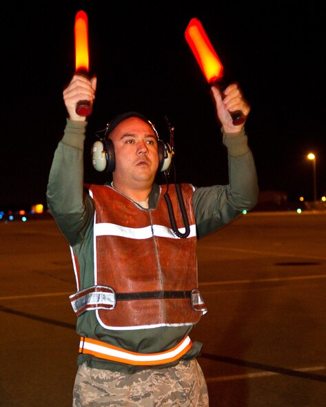 U.S. Air Force Senior Airman Stephen Carson, 461st Air Control Wing, waits for the signal to pull the chocks from the nose gear on a E-8 Joint STARS prior to launch at Robins Air Force Base, Ga., Feb. 15, 2012.  Carson works the nightshift as a crew chief on the Joint STARS aircraft.
(National Guard photo by Master Sgt. Roger Parsons/Released)
