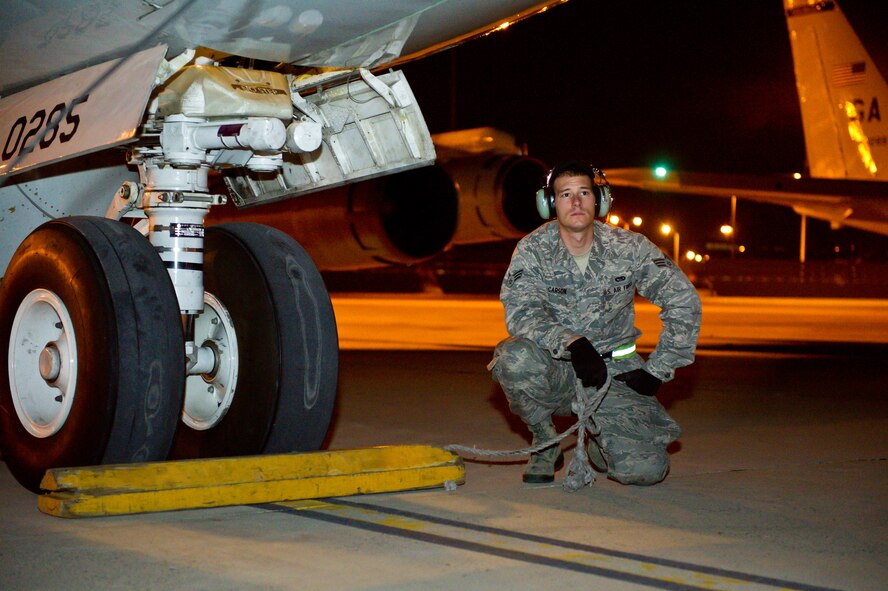 U.S. Air Force Senior Airman Stephen Carson, 461st Air Control Wing, waits for the signal to pull the chocks from the nose gear on a E-8 Joint STARS prior to launch at Robins Air Force Base, Ga., Feb. 15, 2012.  Carson works the nightshift as a crew chief on the Joint STARS aircraft.
(National Guard photo by Master Sgt. Roger Parsons/Released)

