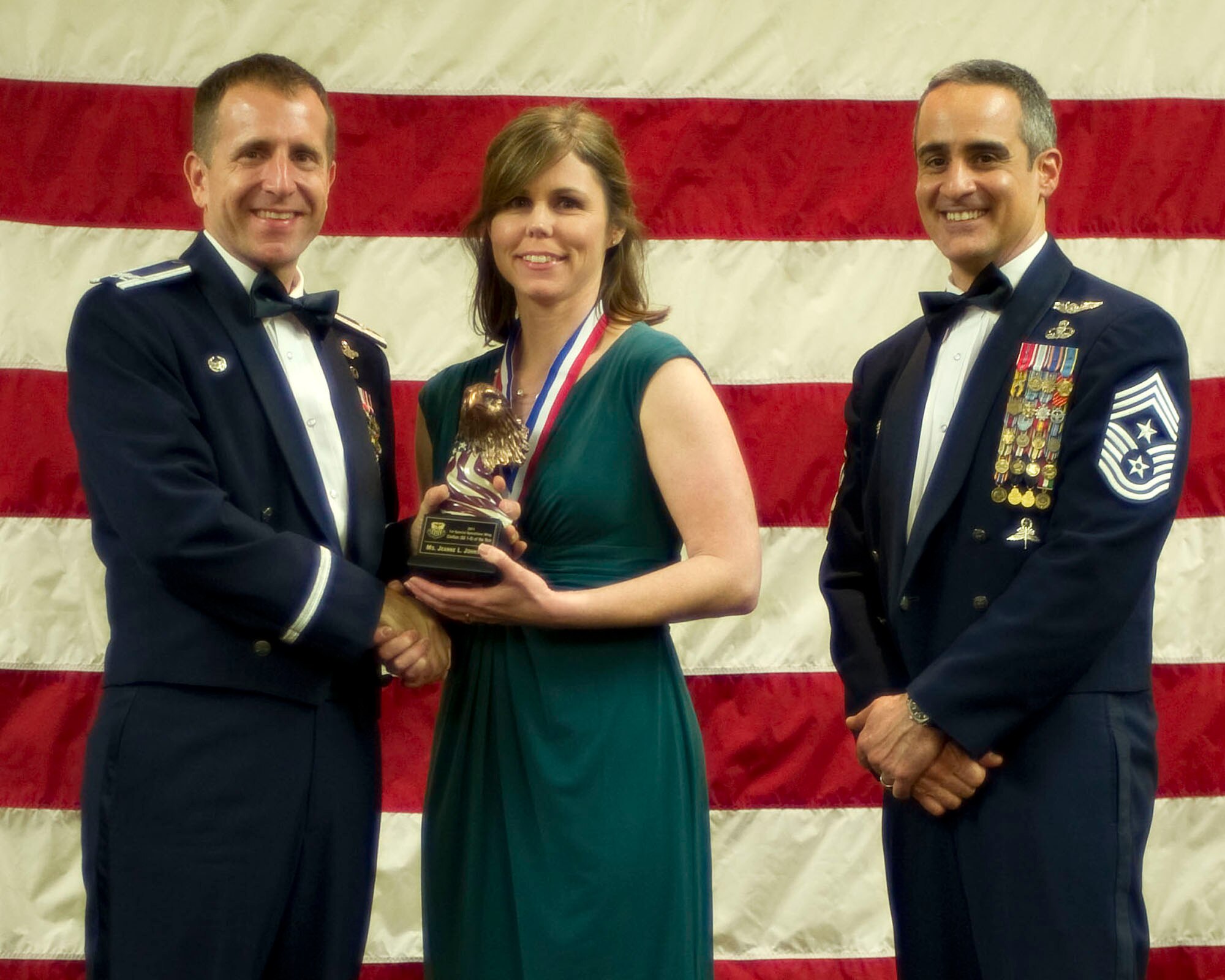 Col. Jim Slife, commander of the 1st Special Operations Wing, left, and Chief Master Sgt. Ramon Colon-Lopez, command chief of the 1st SOW, right, present Jeanne Johnson, 1st Special Operations Maintenance Squadron, center, with the 1st Special Operations Wing GS 1-8 Civilian of the Year award at the 2011 Team Hurlburt Annual Awards Banquet at the Soundside Club at Hurlburt Field, Fla., Feb. 24, 2012. (U.S. Air Force photo by Airman 1st Class Gustavo Castillo) (Released) 