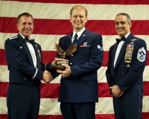 Col. Jim Slife, commander of the 1st Special Operations Wing, left, and Chief Master Sgt. Ramon Colon-Lopez, command chief of the 1st SOW, right, present Senior Airman Joe McFadden, a public affairs specialist from the 1st SOW, center, with the Team Hurlburt Airman of the Year award at the 2011 Team Hurlburt Annual Awards Banquet at the Soundside Club at Hurlburt Field, Fla., Feb. 24, 2012. (U.S. Air Force photo by Airman 1st Class Gustavo Castillo) (Released) 