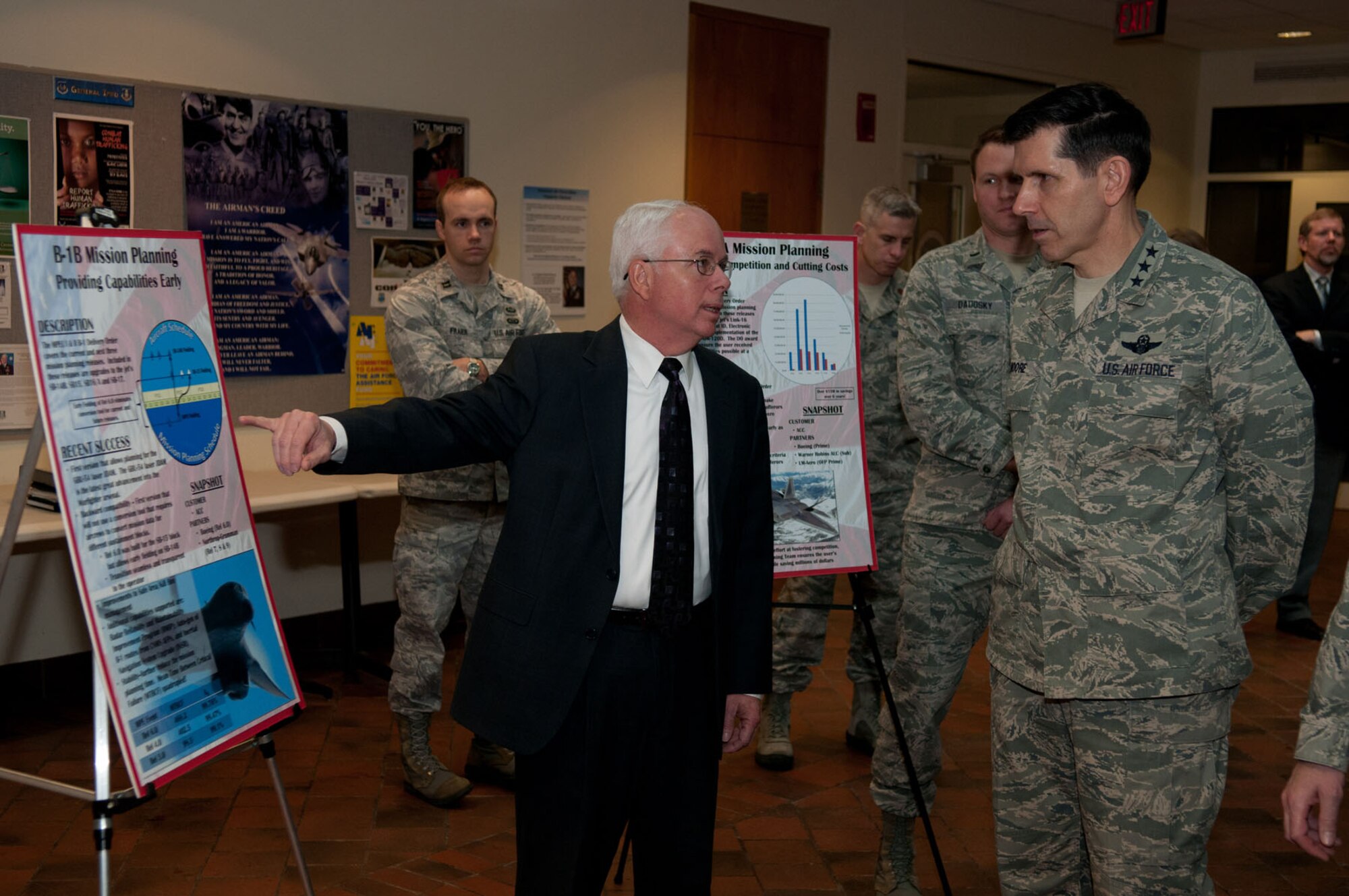 Lt. Gen. C.D. Moore II, Air Force Materiel Command vice commander, who has recently been nominated for the position of Air Force Life Cycle Management Center commander, is  visiting Hanscom AFB, Mass., this week. Moore received an overview about the base and the work done at the Electronic Systems Center. Here, Moore receives an update on Mission Planning from Randy Bowlby (center), Mission Planning program manager, March 1. (U.S. Air Force photo by Rick Berry)