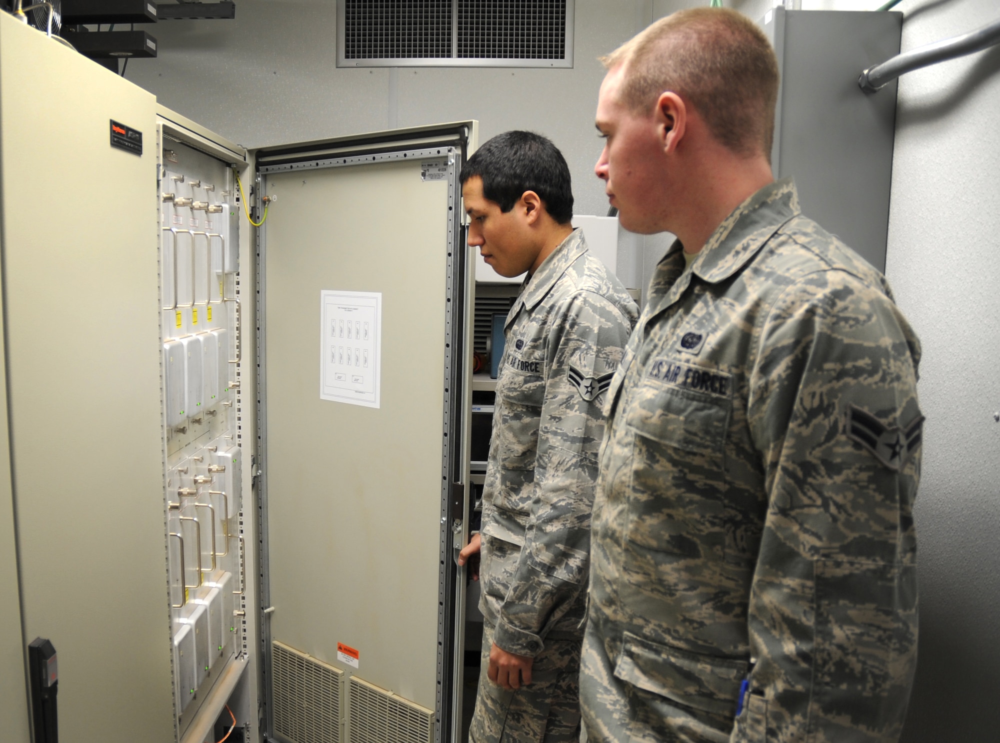 U.S. Air Force Airmen 1st Class Greg Stanley and Jordan Ortiz, 27th Special Operations Communications Squadron radar maintainers, inspect transmission components of the Digital Airport Surveillance Radar at Cannon Air Force Base, N.M., Feb. 24, 2012. The DASR system will replace the existing Airport Surveillance Radar in May 2012. (U.S. Air Force photo by Airman 1st Class Alexxis Pons Abascal) 