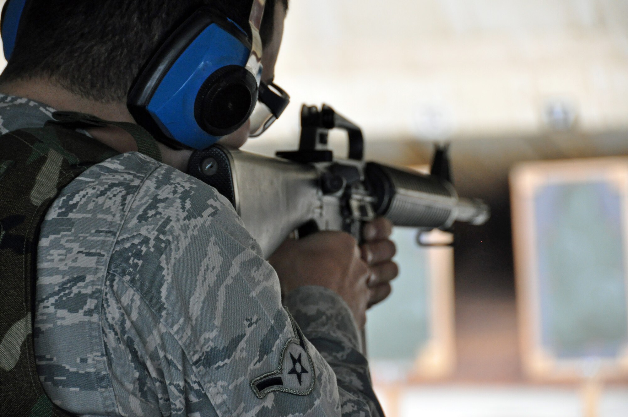 Airman Sargon Zaya, 60th Arial Port Squadron, aims carefully and prepares to pull the trigger at the combat arms training and maintenance firing range Wednesday during his shooting qualification. (U.S. Air Force photo/Airman 1st Class Madelyn Ottem)