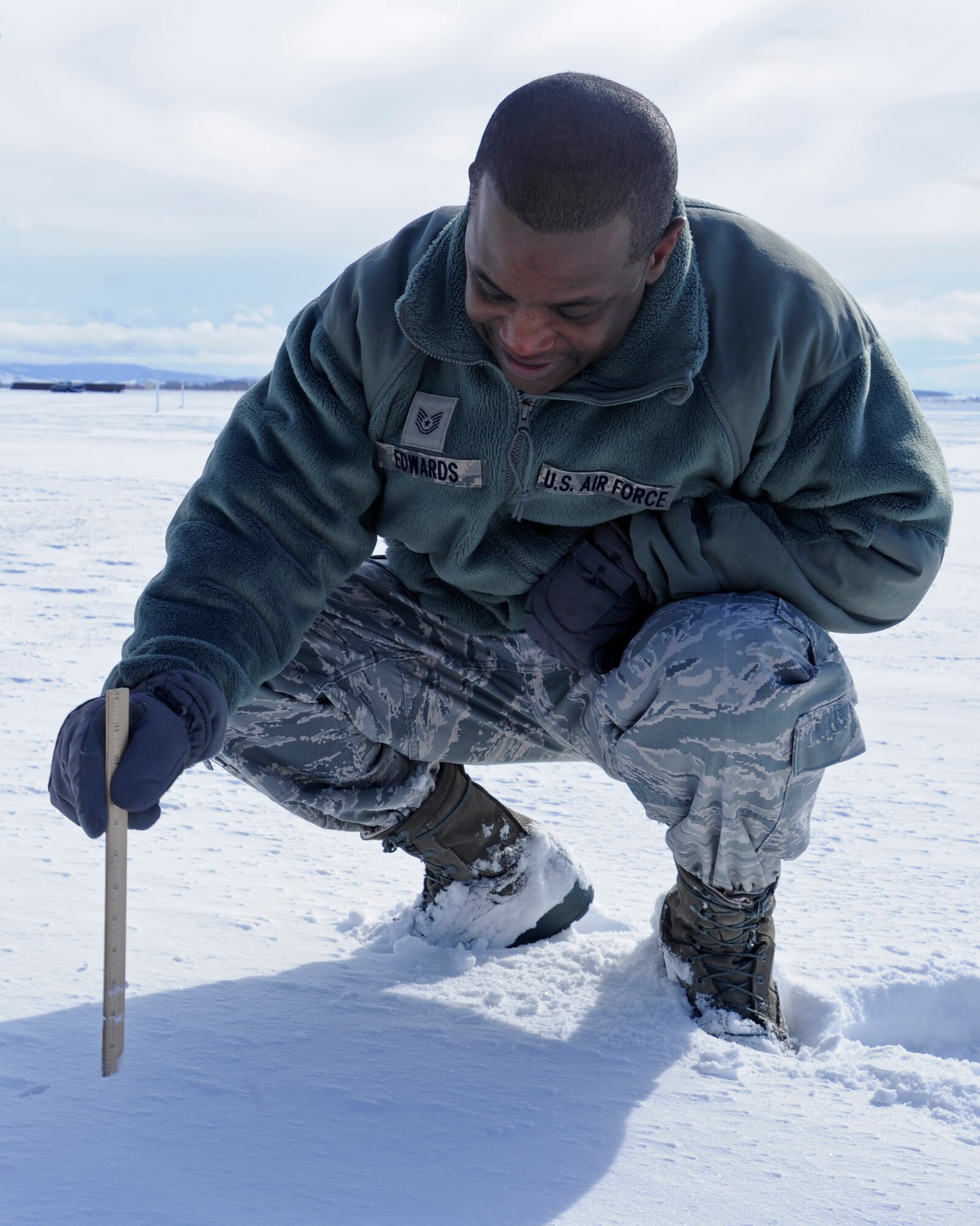 Tech Sgt. Kevin Edwards, 92nd Operations Support Squadron weather forecaster, measures the snow depth at Fairchild Air Force Base, Wash., Feb. 29, 2012. Edwards obtains a new depth reading every six hours to determine any acumination. The current depth was 3-inches. (U.S. Air Force photo by Airman 1st Class Ryan Zeski)