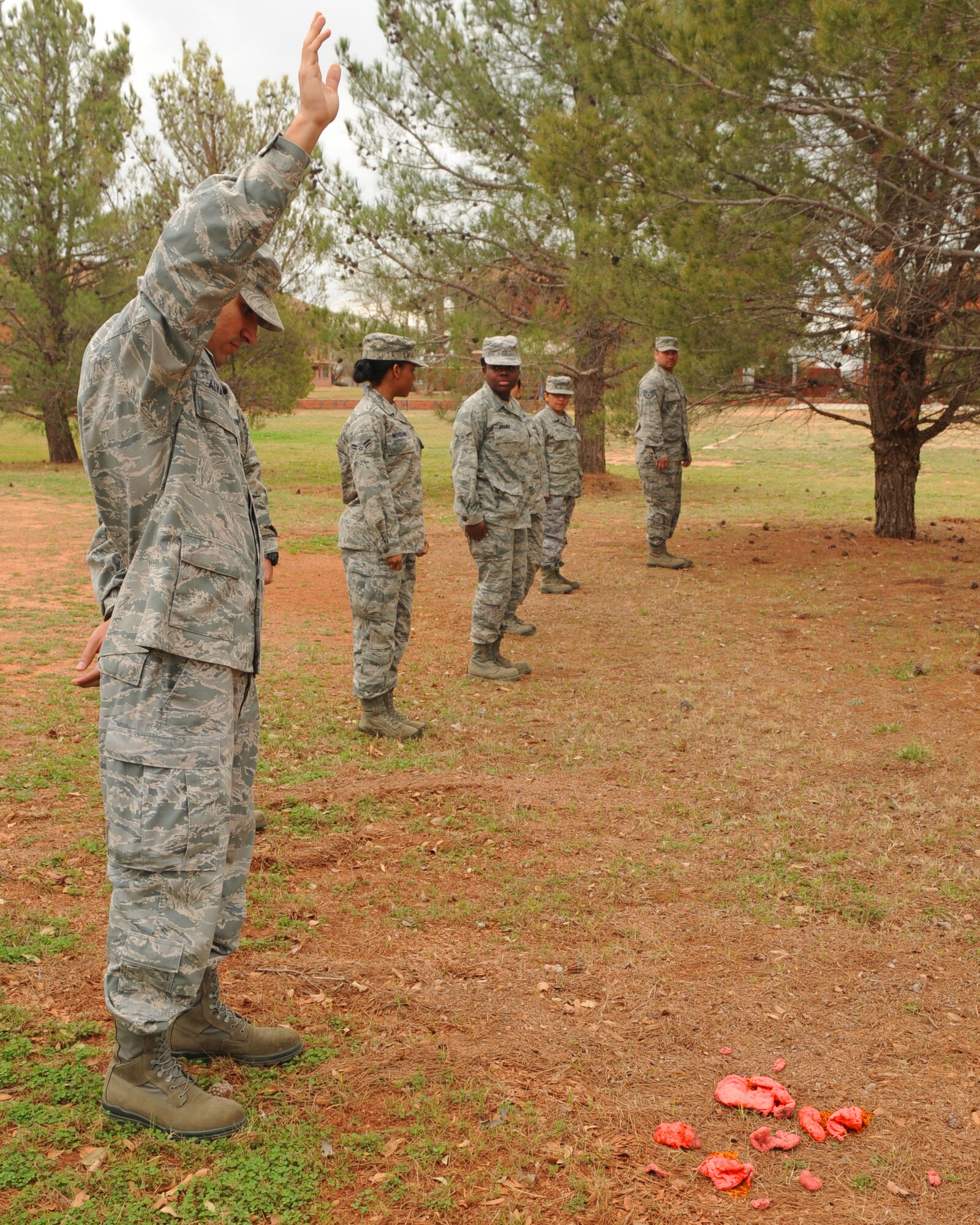 U.S. Air Force Staff Sgt. Joshua Alvarez, 7th Force Support Squadron, signals to instructors that he found remains during search and recovery training Feb. 27, 2012, at Dyess Air Force Base, Texas. The training focuses on ensuring Airmen are aware of how to properly conduct search and recovery in the event of a real-world incident. (U.S. Air Force photo by Airman 1st Class Cierra Bullock/Released)