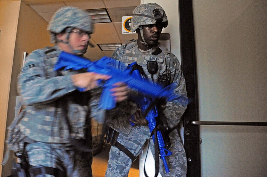 LAUGHLIN AIR FORCE BASE, Texas – Security forces Airmen rush into a barricaded room where three unharmed individuals were waiting to be rescued during an active shooter exercise here Feb. 28. (U.S. Air Force photo/Senior Airman Scott Saldukas)