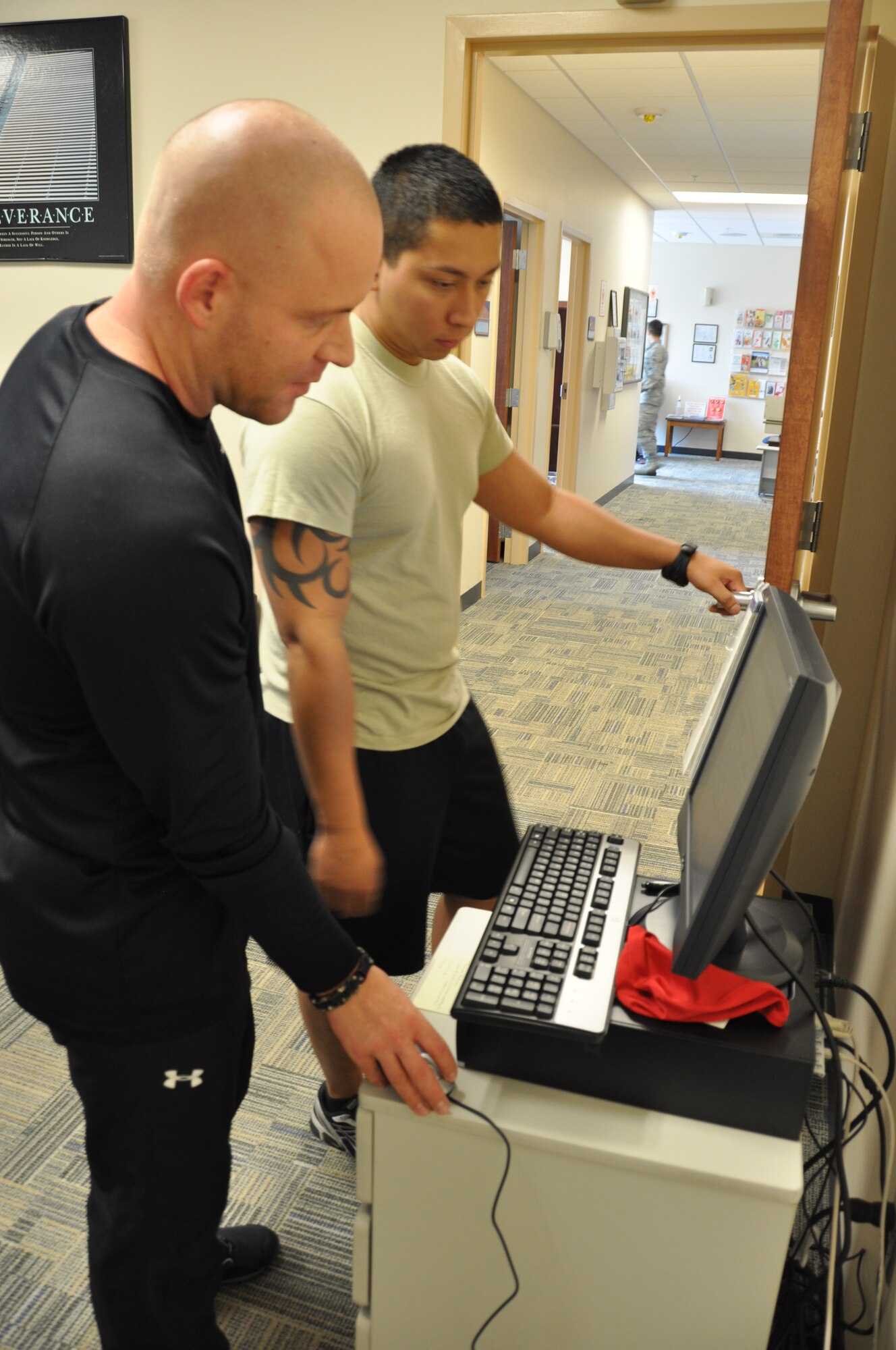 Robert Pagenkopf, 325th Aeromedical Squadron exercise physiologist, inserted Senior Airman Danyel Alvarez, 325th Maintenance Operations Squadron, height and weight into the computer to assess Airman Alverez’s complete body mass index. (U.S. Air Force photo by Senior Airman Rachelle Elsea)
