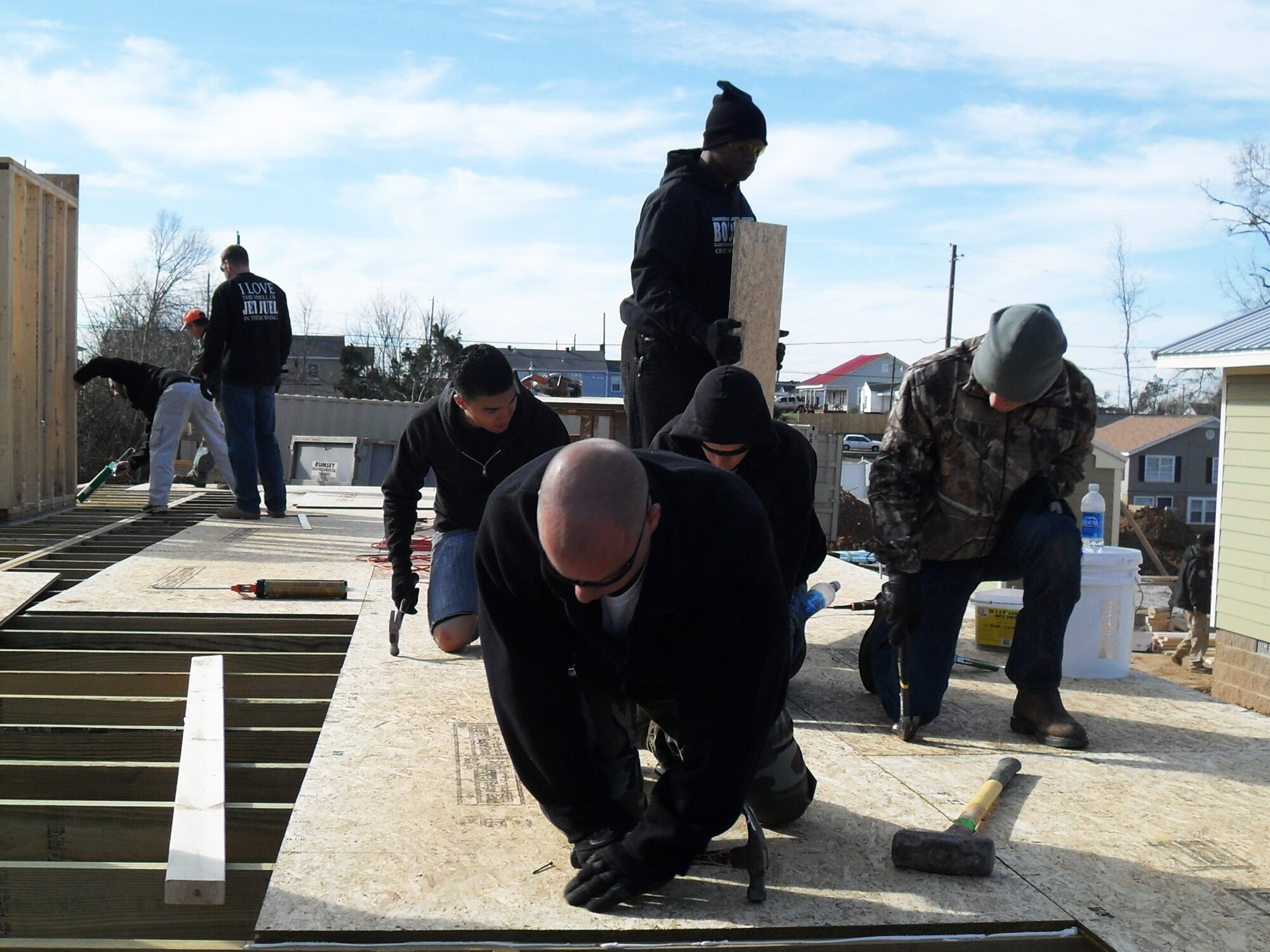 Team Eglin members secure wood for a floor in Tuscaloosa Ala., during a Habitat for Humanity trip.  The Airmen from the Fuels Management Flight and the 96th Dental Squadron, constructed two outdoor storage buildings, finalized the interior of a house, made a front porch deck, laid the base flooring for a house, cut the re-barb for a driveway and sidewalk, constructed three safe rooms and repaired one safe room capable of withstanding 200 mile per hour winds.  The 19 Airmen provided 588 man hours of labor and saved $5,800 in contractor costs over three days.  (Courtesy photo)