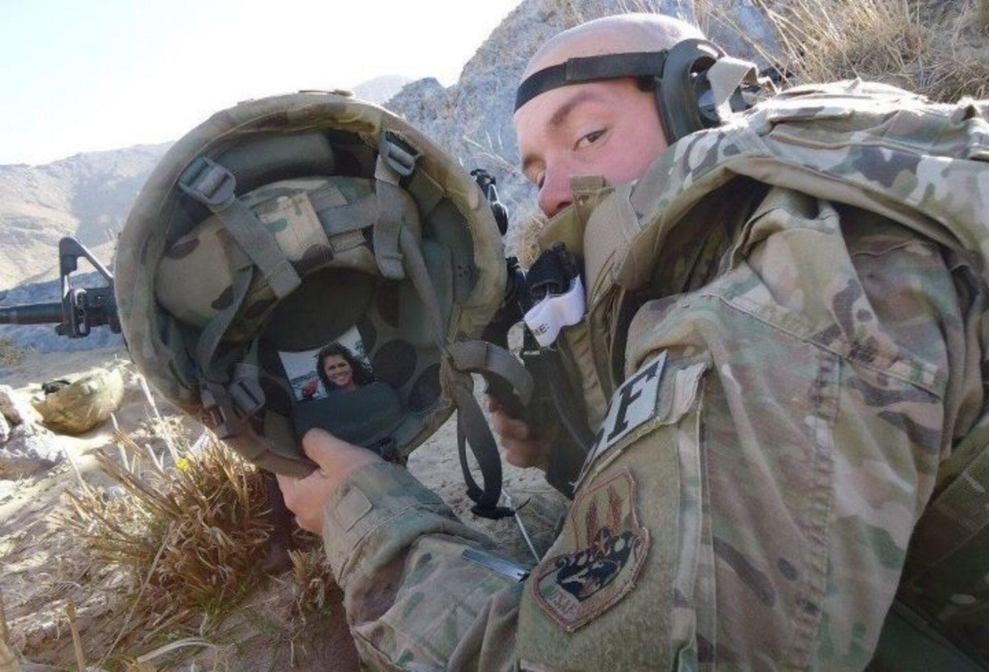 Staff Sgt. Justin Hall, 14th Security Forces Squadron, shows off a picture tucked inside his helmet while deployed as a member of a Security Force Sniper Team to Bagram Air Base, Afghanistan. (Courtesy photo)