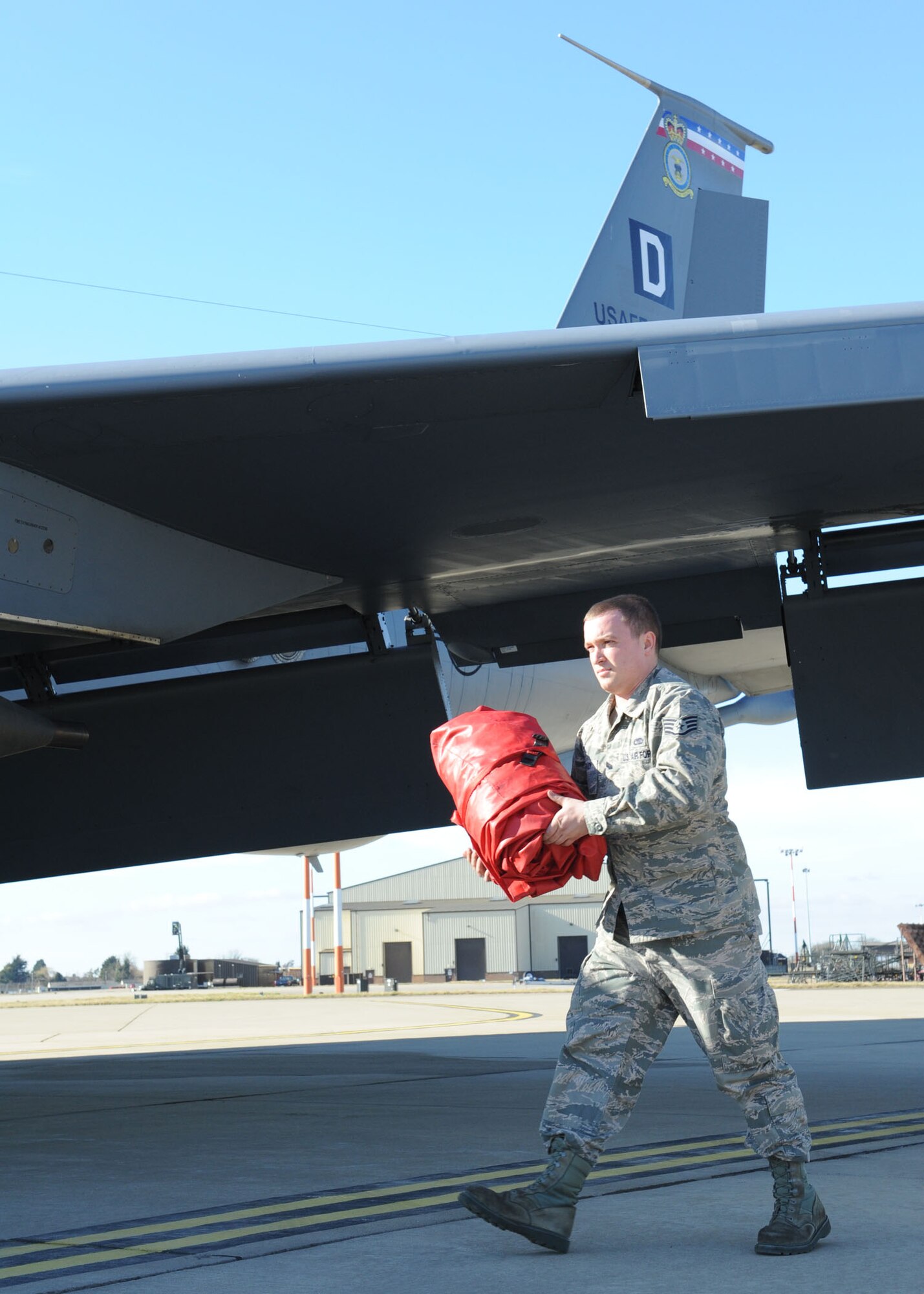 RAF MILDENHALL, England – Staff Sgt. Scott Kenady, 100th Aircraft Maintenance Squadron crew chief, carries an engine cover from a KC-135 Stratotanker aircraft after removing it here Feb. 23, 2012. Kenady, whose job entails all aspects of aircraft service and inspection, works with all aircraft assigned to the 100th Air Refueling Wing but is the dedicated crew chief for the wing’s flagship aircraft. (U.S. Air Force photo/Tech. Sgt. Neal X. Joiner) 