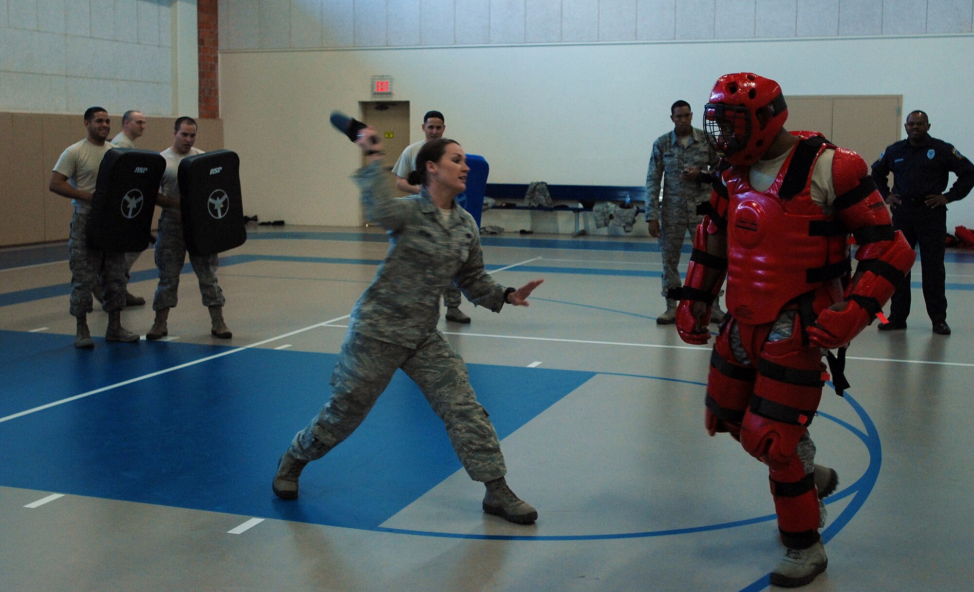 GOODFELLOW AIR FORCE BASE, Texas --Airman 1st Class Megan Regan, 17th Security Forces Squadron, takes a swing at Staff Sgt. Vernon Boyd, 17th Security Forces Squadron, with a baton Feb. 29, here. This training drill, consisting of defending against a mock assailant with a baton, is done yearly by Air Force Security Forces. (U.S. Air Force photo/Airman 1st Class Michael Smith)