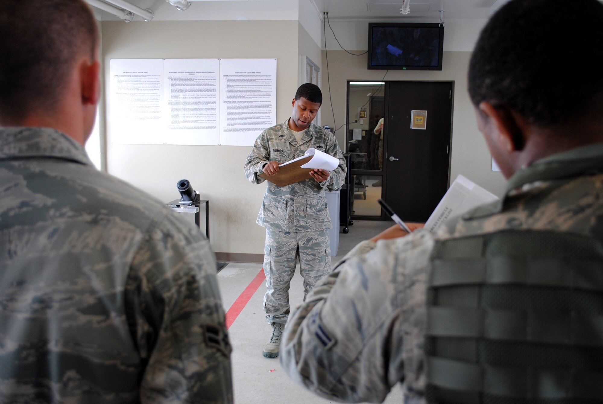Staff Sgt. Atkins Riddick, 319th Security Forces assistant flight sergeant for Bravo Flight, briefs security forces Airmen on what road hazardous and weather conditions to expect while on patrol. Riddick ensured the defenders took note of changes to force protection conditions and other law enforcement-related updates during guard mount, Feb. 29, 2012 at the armory on Grand Forks Air Force Base, N.D. Guard mount refers to an official formation among designated Air Force security forces members, which is typically held after all security personnel have received their weapons and equipment before the start of their respective shift. (U.S. Air Force photo/Senior Airman Luis Loza Gutierrez)