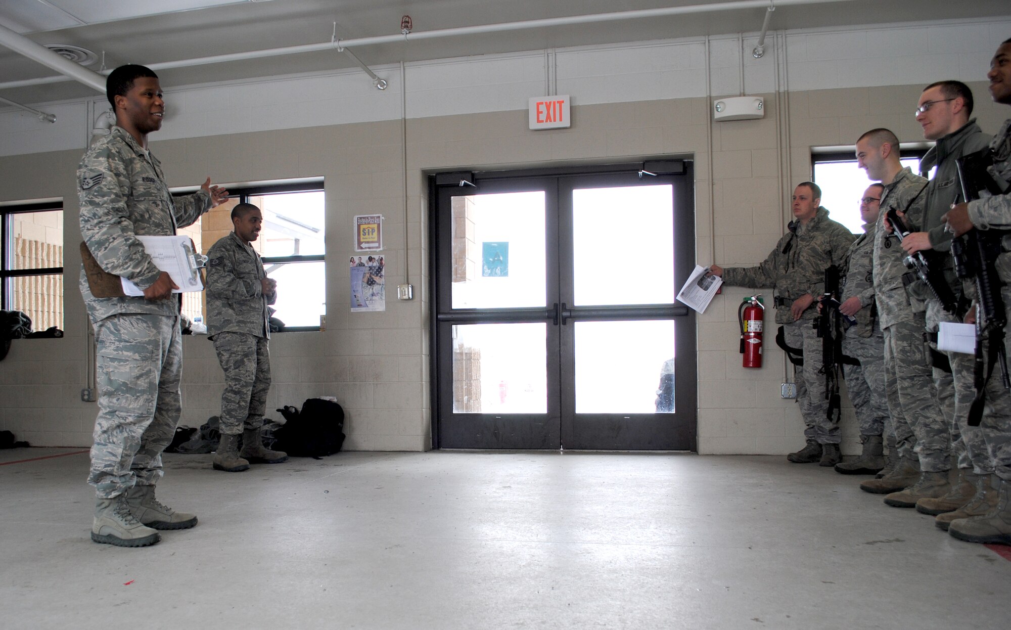 Staff Sgt. Atkins Riddick, 319th Security Forces assistant flight sergeant for Bravo Flight, briefs security forces Airmen on what type of road violations to expect while on patrol. Riddick briefed the defenders during guard mount, Feb. 29, 2012 at the armory on Grand Forks Air Force Base, N.D. Guard mount refers to an official formation among designated Air Force security forces members, which is typically held after all security personnel have received their weapons and equipment before the start of their respective shift. (U.S. Air Force photo/Senior Airman Luis Loza Gutierrez)