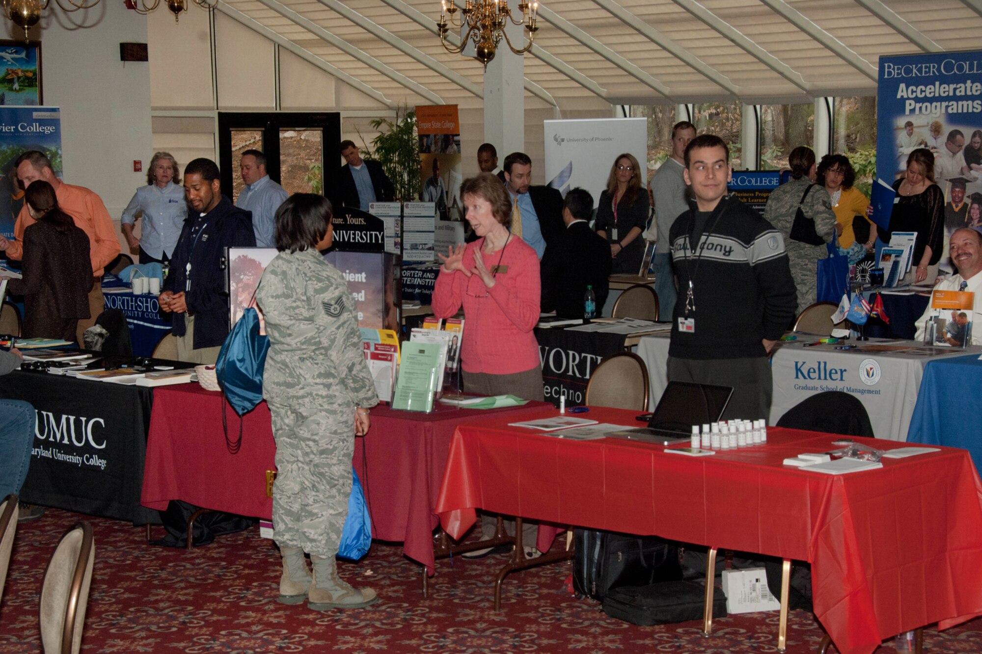 HANSCOM AIR FORCE BASE, Mass. – Education Fair attendees talk to school representatives about the opportunities offered at the many colleges and universities in attendance during Hanscom’s first education fair of the year. The event coincides with Air Force Materiel Command’s emphasis on the Year of Continuing Education (YoCE), which encourages Airmen to pursue a degree or professional certificate. (U.S. Air Force photo by Linda LaBonte Britt) 