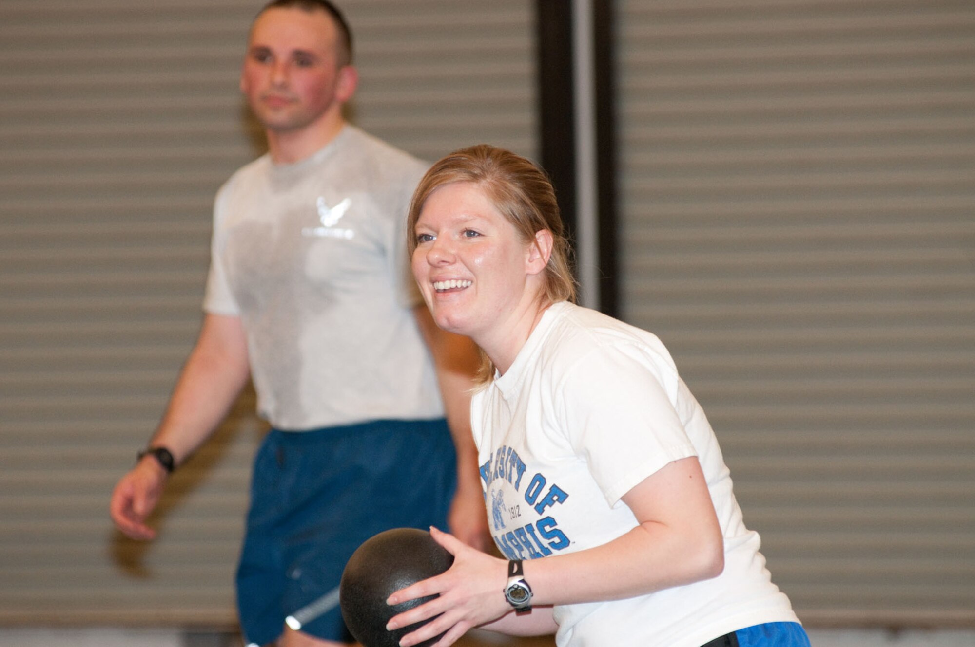HANSCOM AIR FORCE BASE, Mass. – 2nd Lt. Bethany Parker prepares to throw the ball while teammate 1st Lt. Daniel Fain tries to avoid being hit during a dodgeball game held at the Fitness Center Feb. 23. The base’s lieutenants took on the captains, with the lieutenants bringing home the victory due to their superior dodging, dipping, ducking and diving skills. (U.S. Air Force Photo by Mark Herlihy)