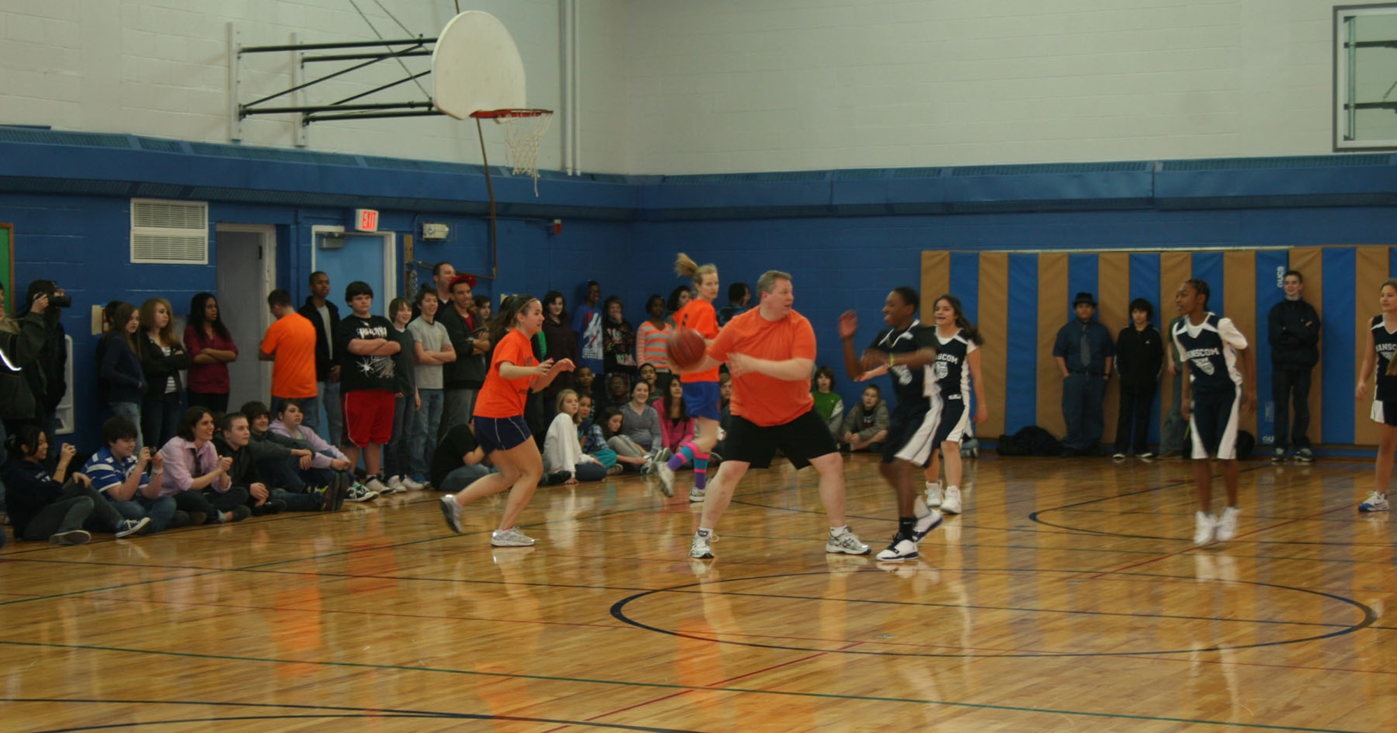 HANSCOM AIR FORCE BASE, Mass. – Hanscom Middle School Principal Erich Ledebuhr (with basketball) prepares to make a pass during the annual HMS "teachers vs. students" basketball game. The teachers played against sixth, seventh and eighth grade students, while the entire HMS staff and student body cheered them on. The teachers won 41-40. (Courtesy photo)