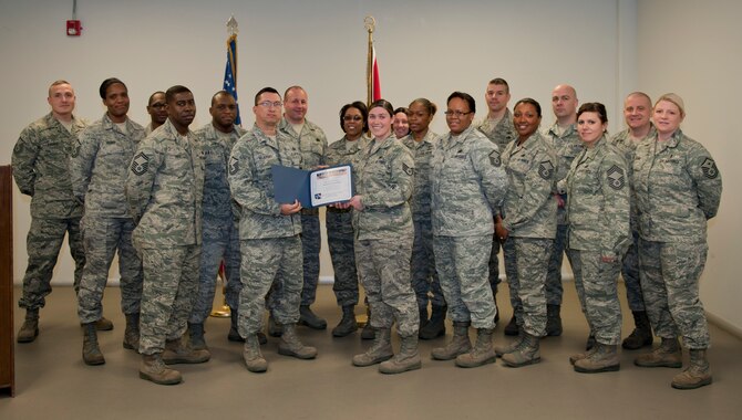 Staff Sgt. Jessica Robbins, 39th Logistics Readiness Squadron, receives the Unsung Hero Award from the Incirlik Top 3 organization Feb. 24, 2012, at Incirlik Air Base, Turkey. The Top 3 presents this award monthly to Airmen who demonstrate superior job performance and exceptional leadership. (U.S. Air Force photo by Senior Airman Anthony Sanchelli/Released)