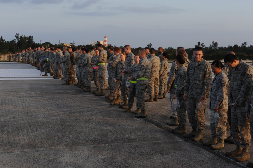 Airmen from Kadena Air Base wait for the Foreign Object Debris (FOD) walk to begin on Kadena Air Base, Japan, Feb. 29, 2012. The FOD walk is planned to keep the airfield clean and free of objects such as aircraft and vehicle fasteners, rocks and any hard or soft objects that can damage an aircraft engine or airframe.  (U.S. Air Force photo by Airman 1st Class Justin Veazie)