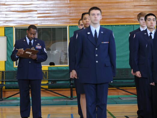 U.S. Air Force Tech. Sgt. Jerald Ford, 373rd Support Squadron production supervisor, finishes an open ranks inspection of the Edgren High School's Junior Reserve Officers' Training Corps, Alpha flight at the Edgren High School gym, Misawa Air Base, Japan, Feb. 29, 2012. The inspection was a part of the JROTC's promotion ceremony where 35th Fighter Wing Airmen participated for the first time. (U.S. Air Force photo by Airman Kenna Jackson/Released)