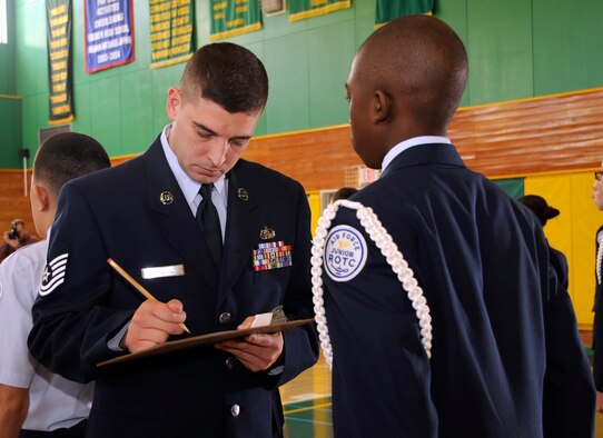 U.S. Air Force Tech. Sgt. Brian Browning, 35th Communications Squadron information protection operations NCO in charge, inspects son of U.S. Air Force Master Sgt. Janisa Wallace, 35th Medical Support Squadron medical information systems flight chief, at Edgren High School Gym, Misawa Air Base, Japan, Feb. 29, 2012. Thirteen servicemembers inspected more than 30 Junior Reserve Officers' Training Corps students' uniforms during an open ranks inspection. (U.S. Air Force photo by Airman 1st Class Kaleb Snay/Released)
